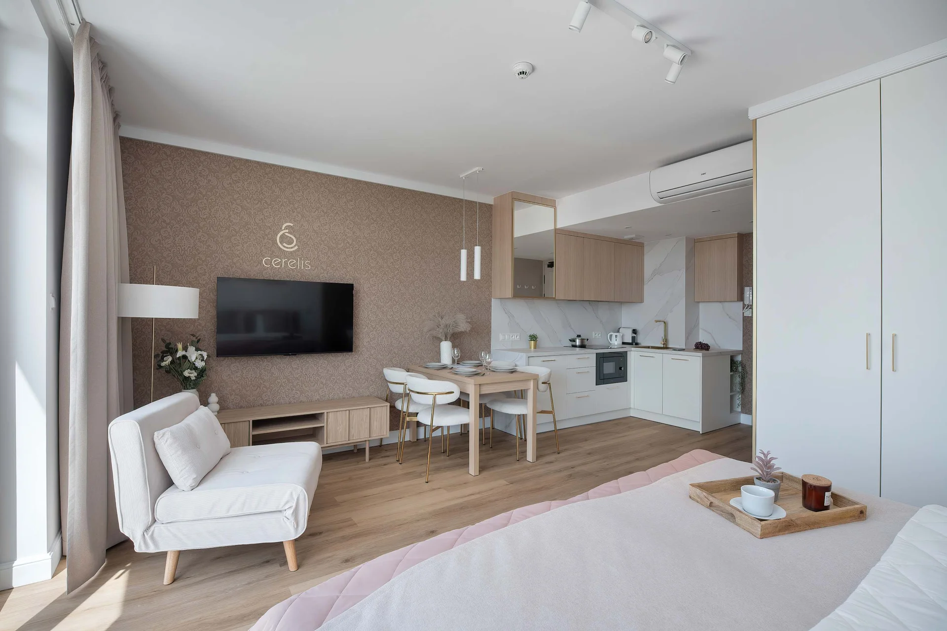 Spacious open-plan studio combining the sleeping, living, and dining areas in a bright, contemporary interior.