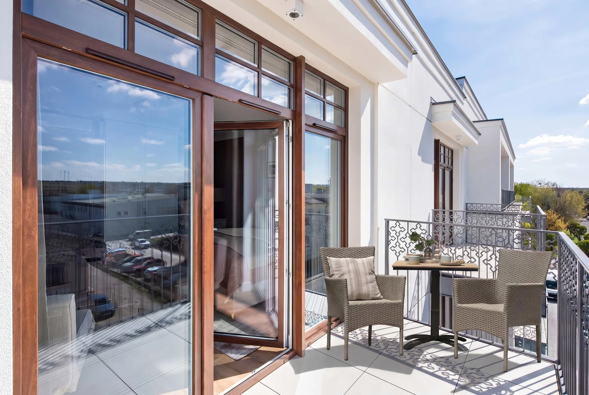 Private balcony furnished with outdoor seating, perfect for enjoying fresh air and city views.