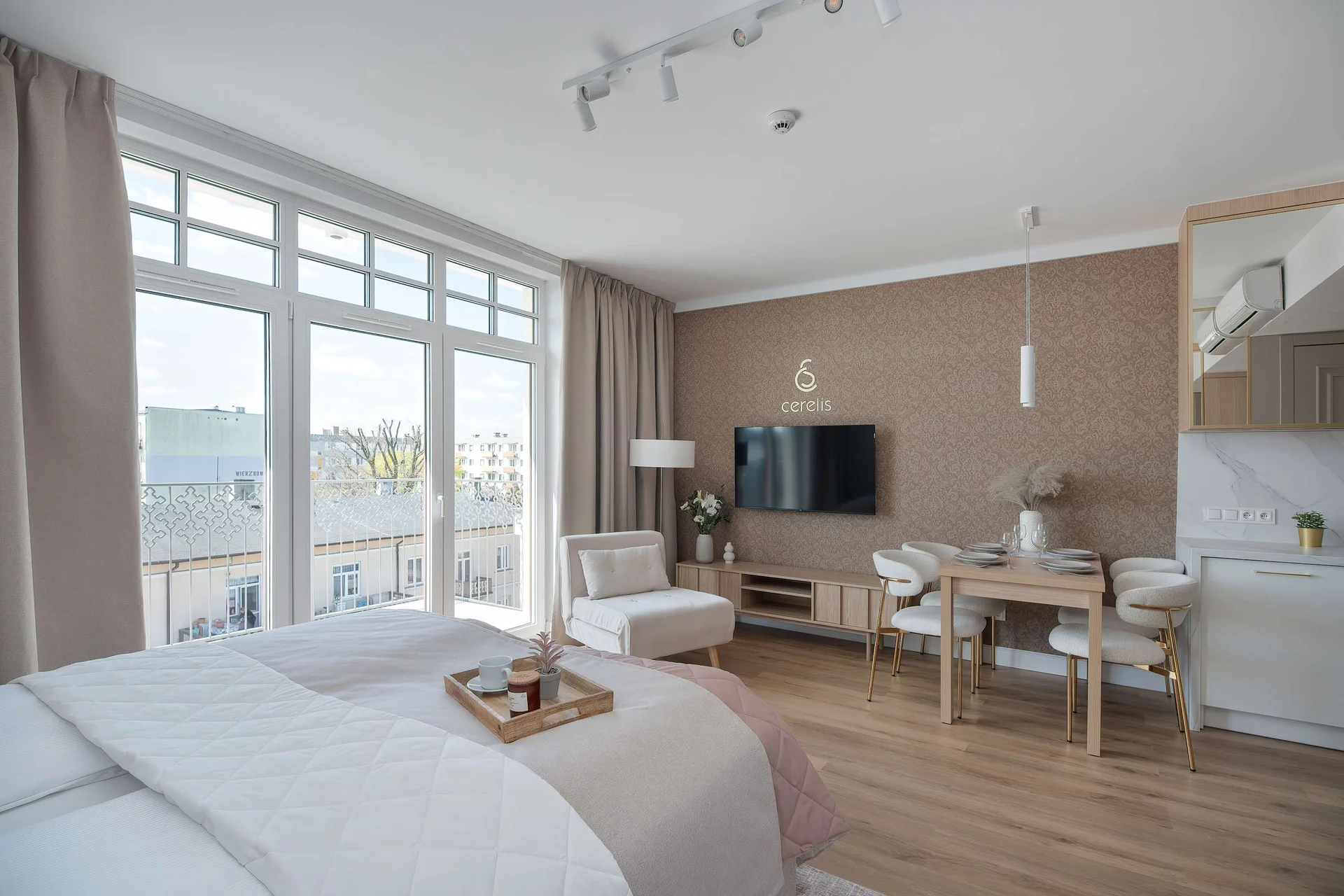 View of the studio from the sleeping area, showcasing the open layout and large windows.