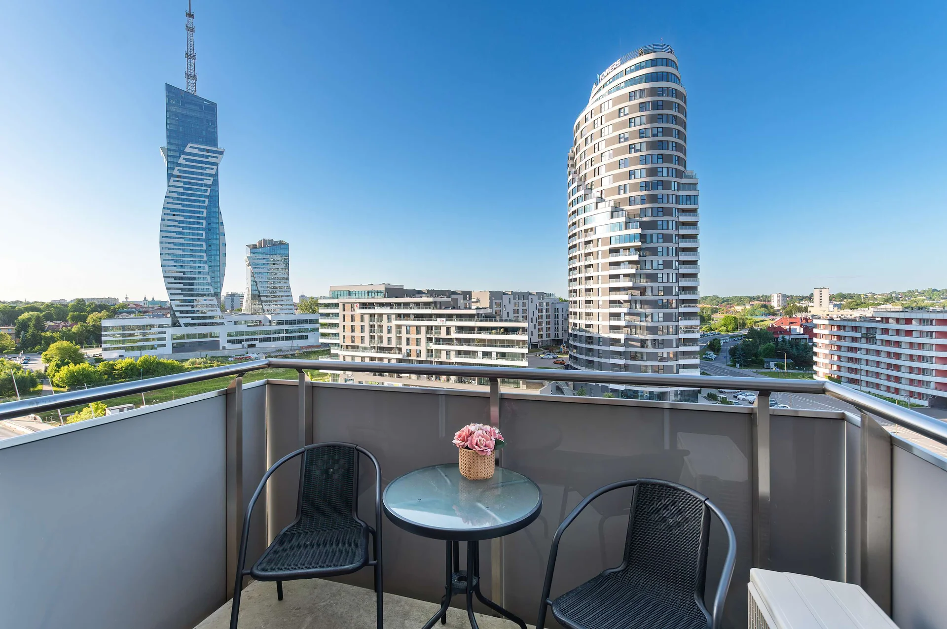 Private balcony with outdoor seating and panoramic city skyline views