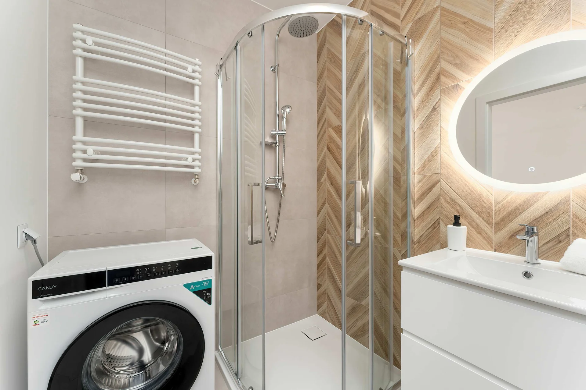 The bathroom's contemporary design includes fresh towels and a hairdryer.