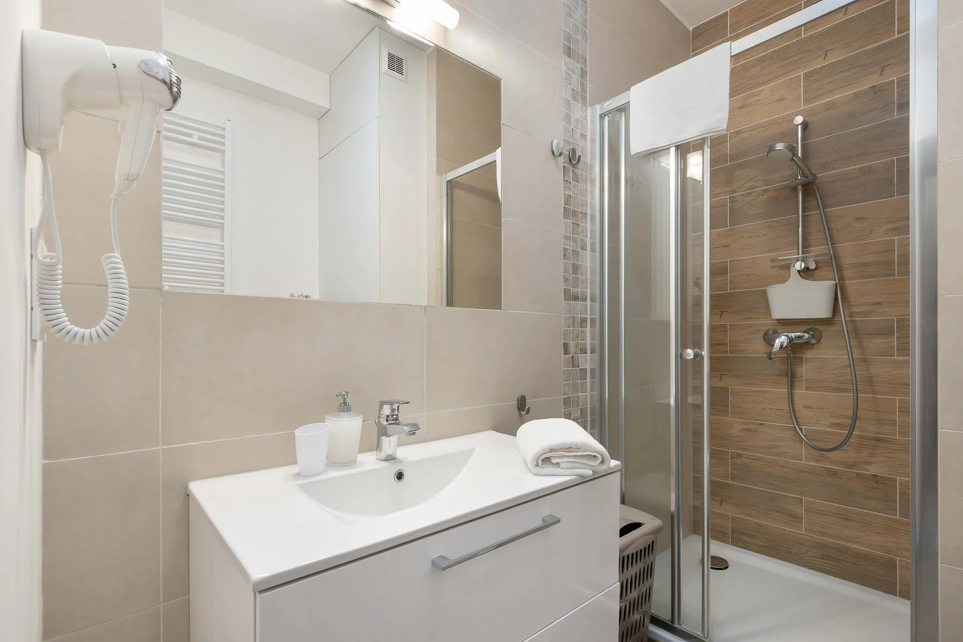 Contemporary bathroom featuring a shower, vanity unit, and modern fittings.