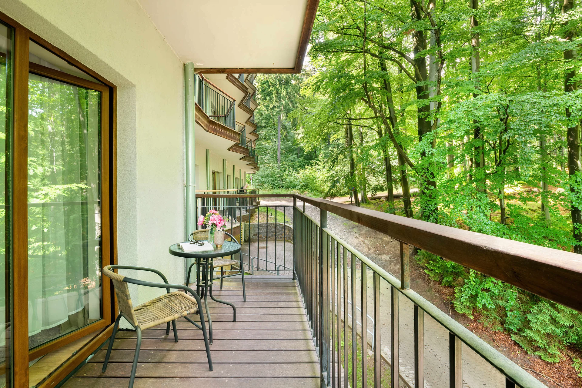 Private balcony surrounded by greenery, offering a peaceful setting to relax and enjoy nature views.