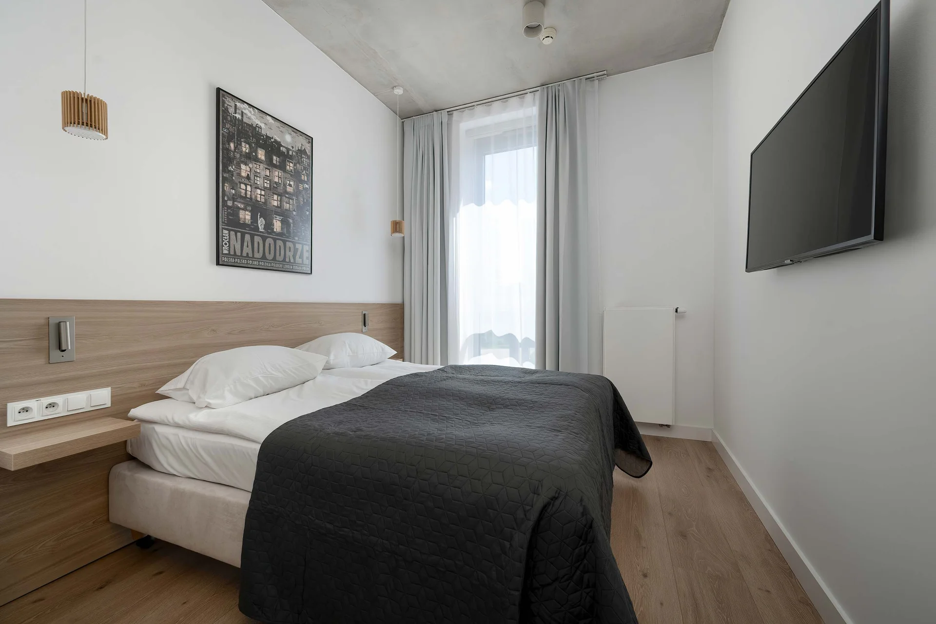 The cosy bedroom features a luxurious double bed and ample storage.