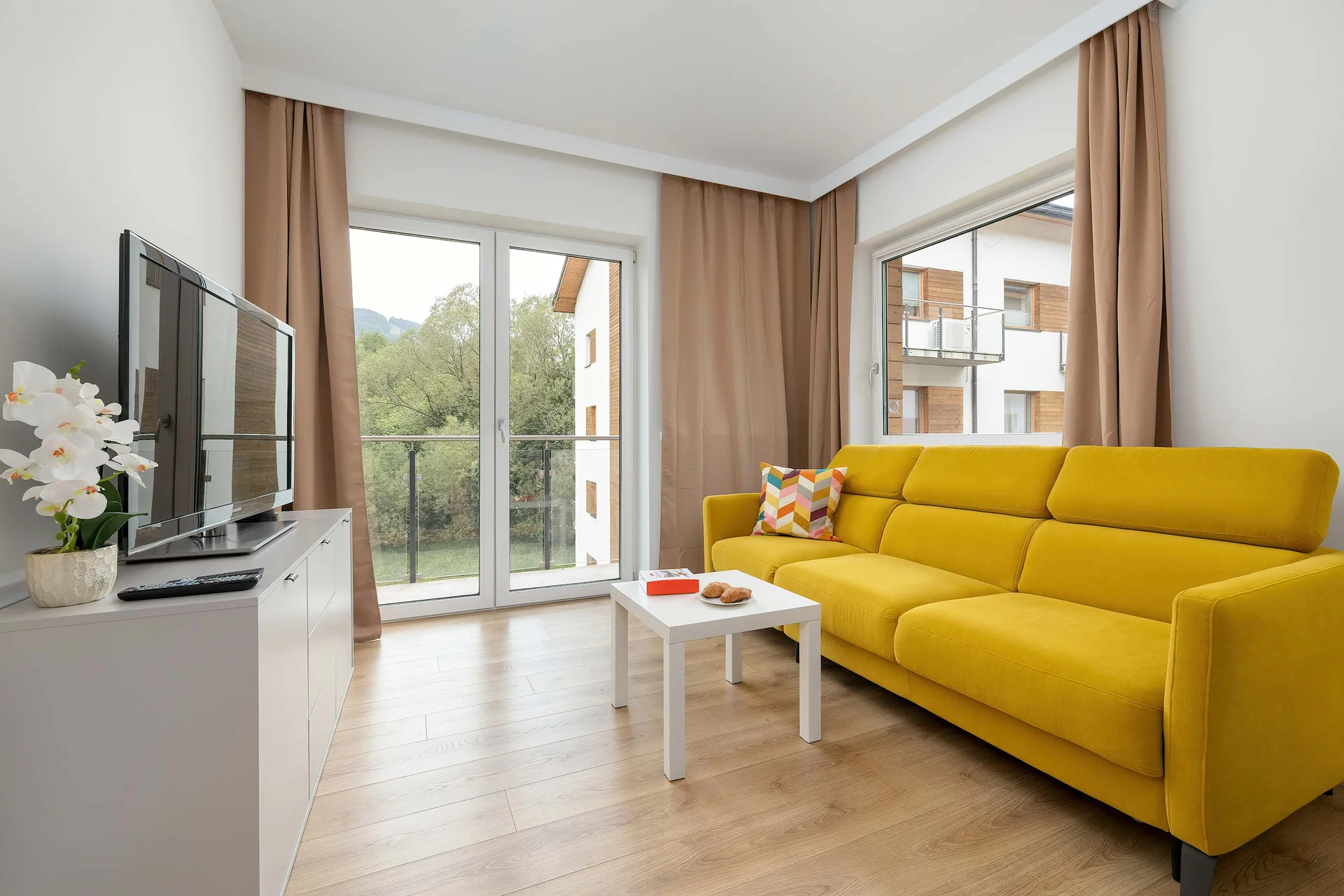 Relax in the stylish living room with a comfortable sofa and modern decor.