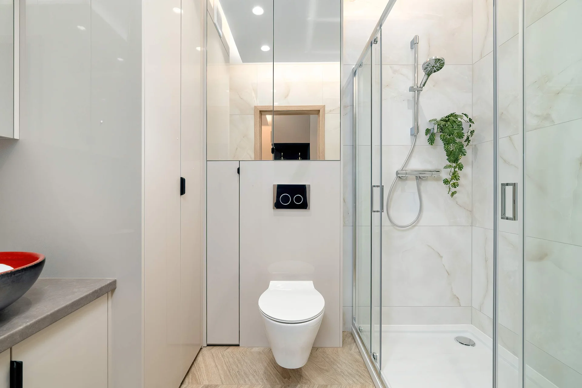 The bathroom's contemporary design includes fresh towels and a hairdryer.