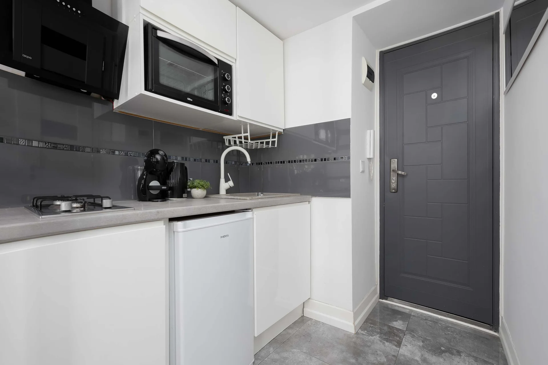 Well-equipped kitchenette with a coffee maker, and storage space.