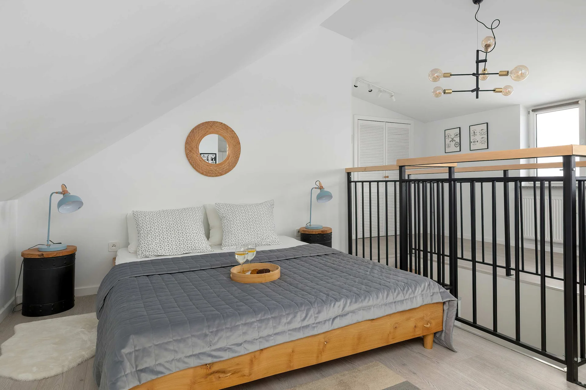 Living room featuring a comfortable double bed, creating a practical sleeping area within the open-plan space.
