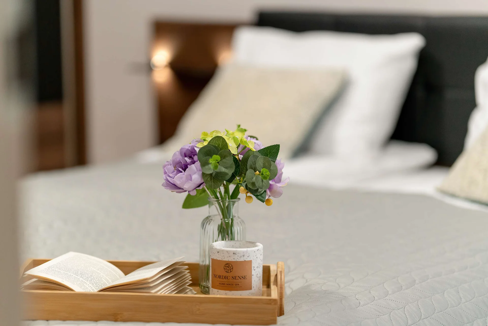 Bedroom detail showcasing premium bedding, fresh flowers and a welcoming atmosphere.