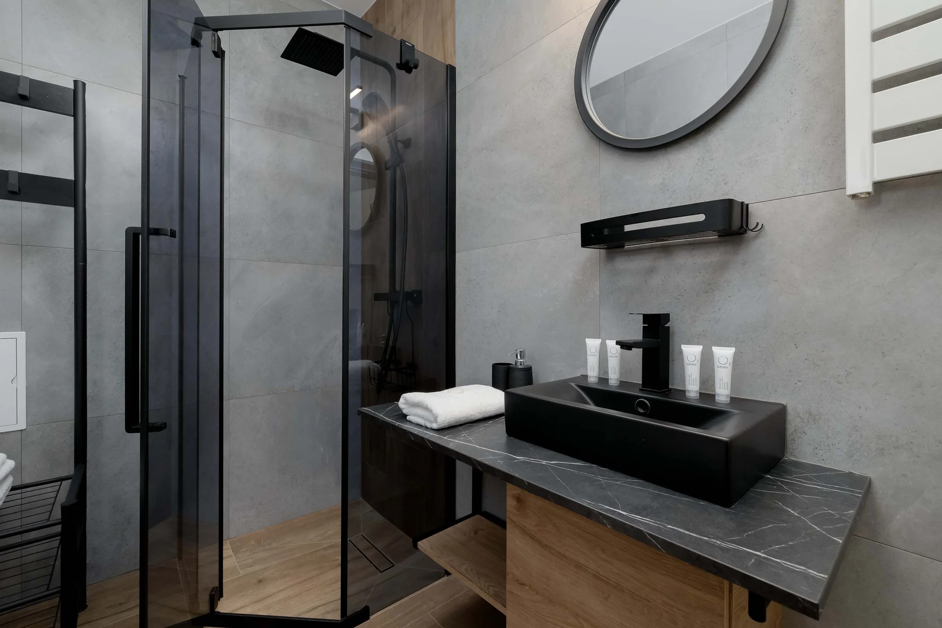 The bathroom's contemporary design includes fresh towels and a hairdryer.