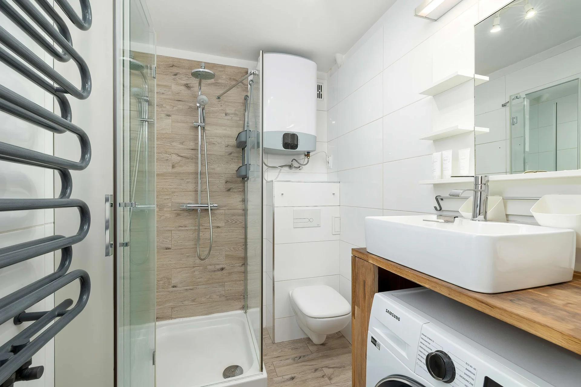 The bathroom's contemporary design includes fresh towels and a hairdryer.
