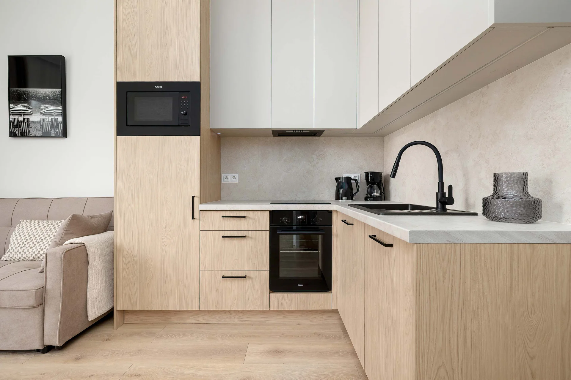 Fully equipped kitchenette with modern appliances, including a cooktop, oven, microwave, and coffee maker.