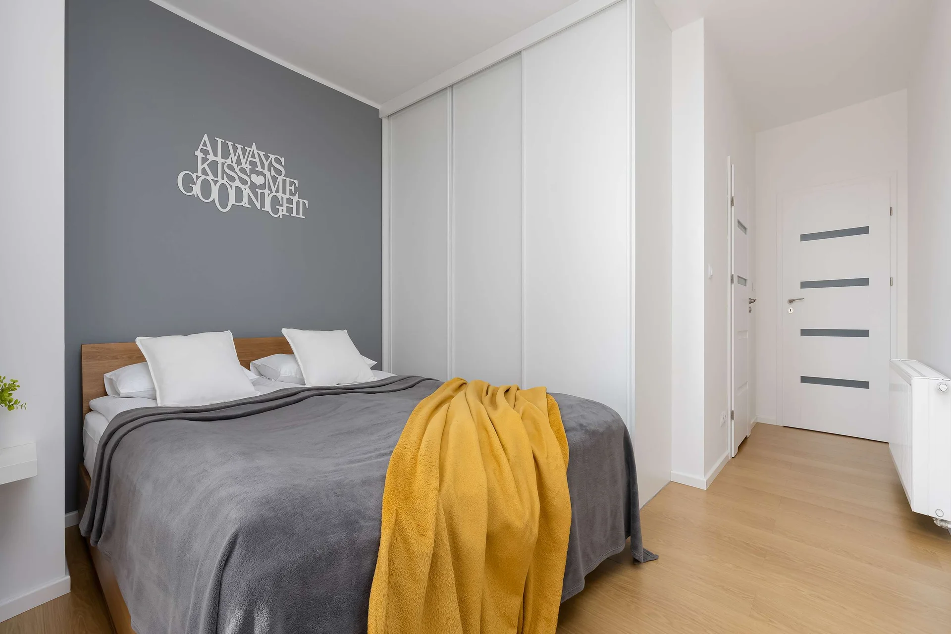 Stylish master bedroom featuring a comfortable double bed, spacious wardrobe, and modern décor.