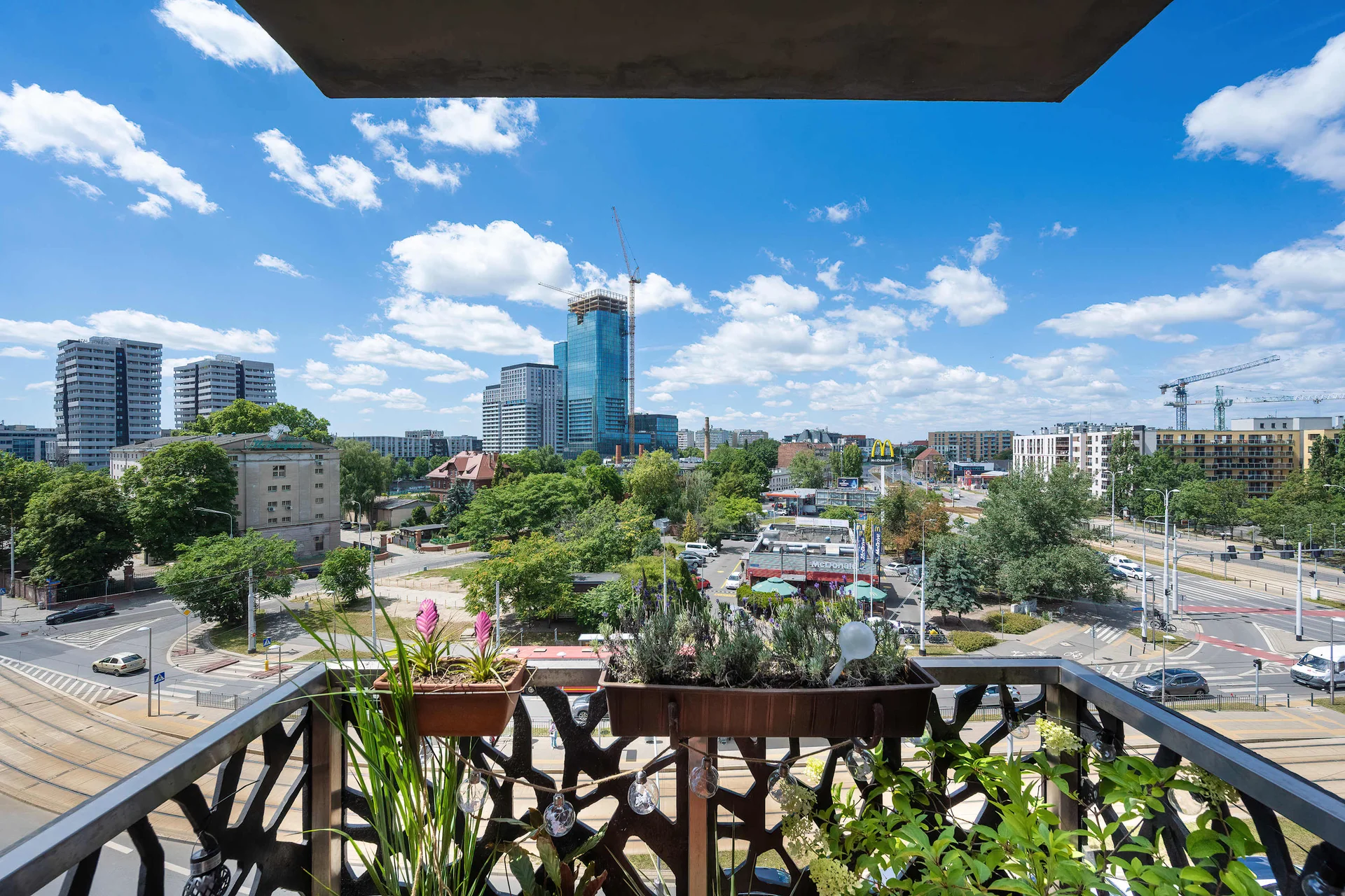 Private balcony offering panoramic views of the city skyline and surrounding residential area.