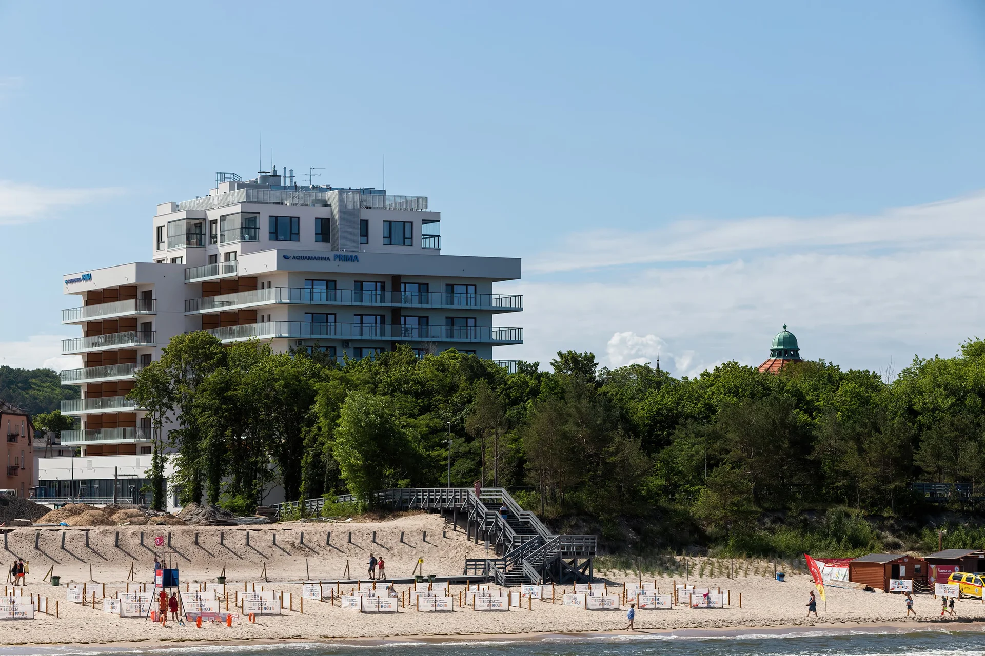 A beach with a view of the modern apartment building.