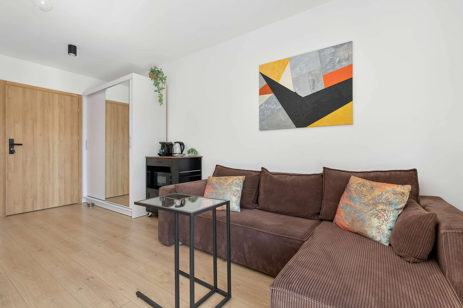 Relax in the stylish living room with a comfortable sofa and modern decor.