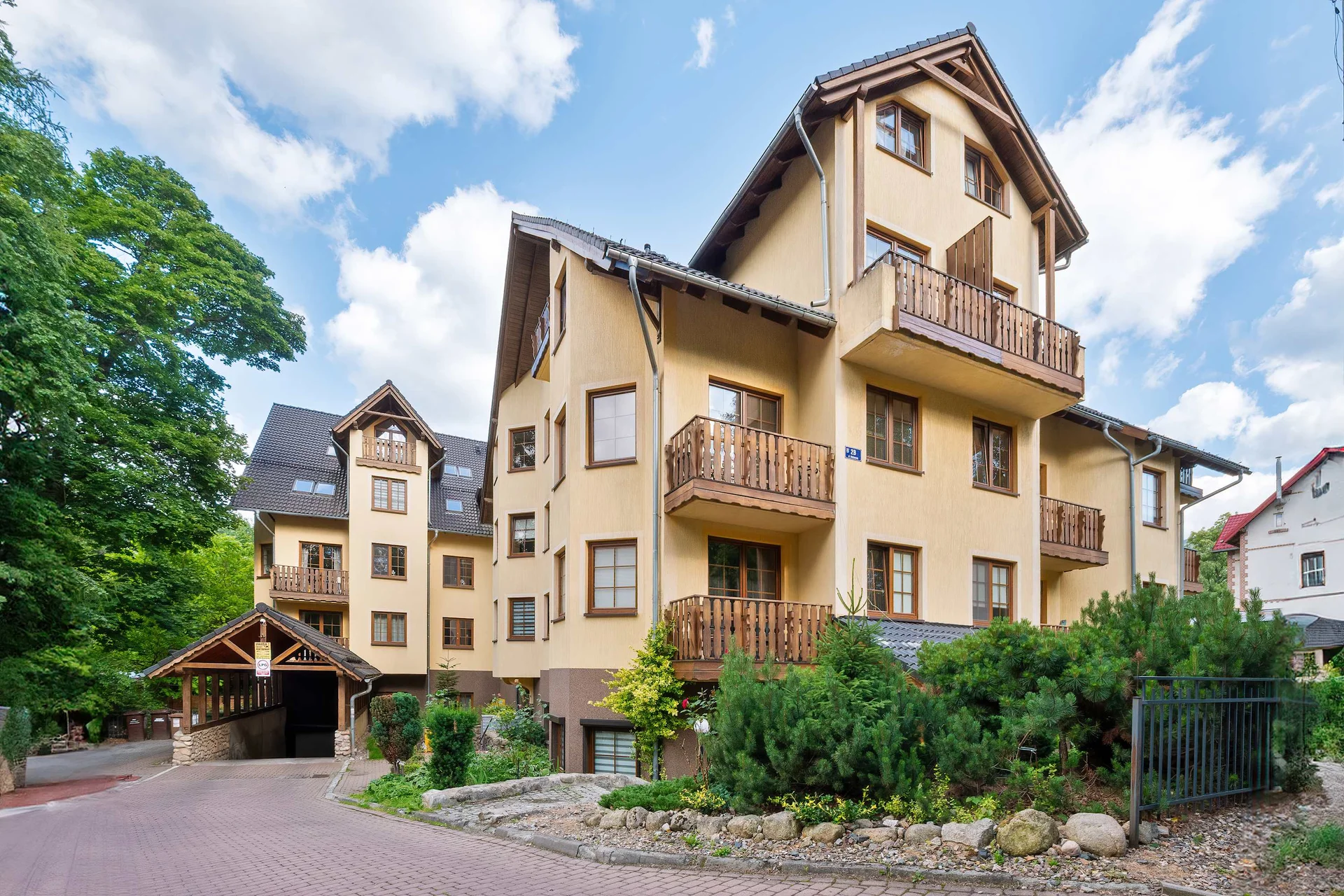 A residential building view, showcasing balconies and the lush landscape. Ideal for enjoying fresh air close to nature.