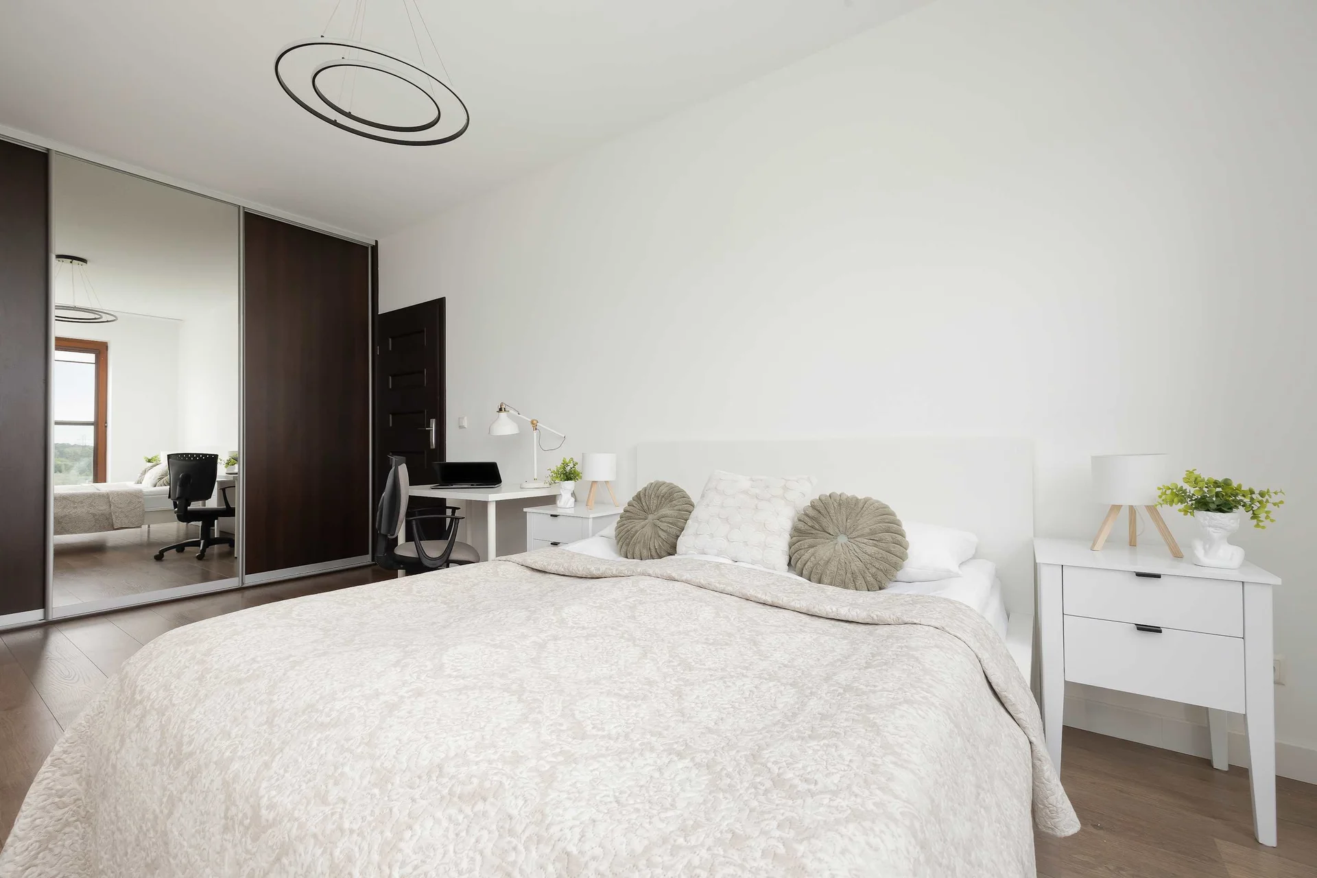 Cozy bedroom with a large wardrobe and minimalist décor.