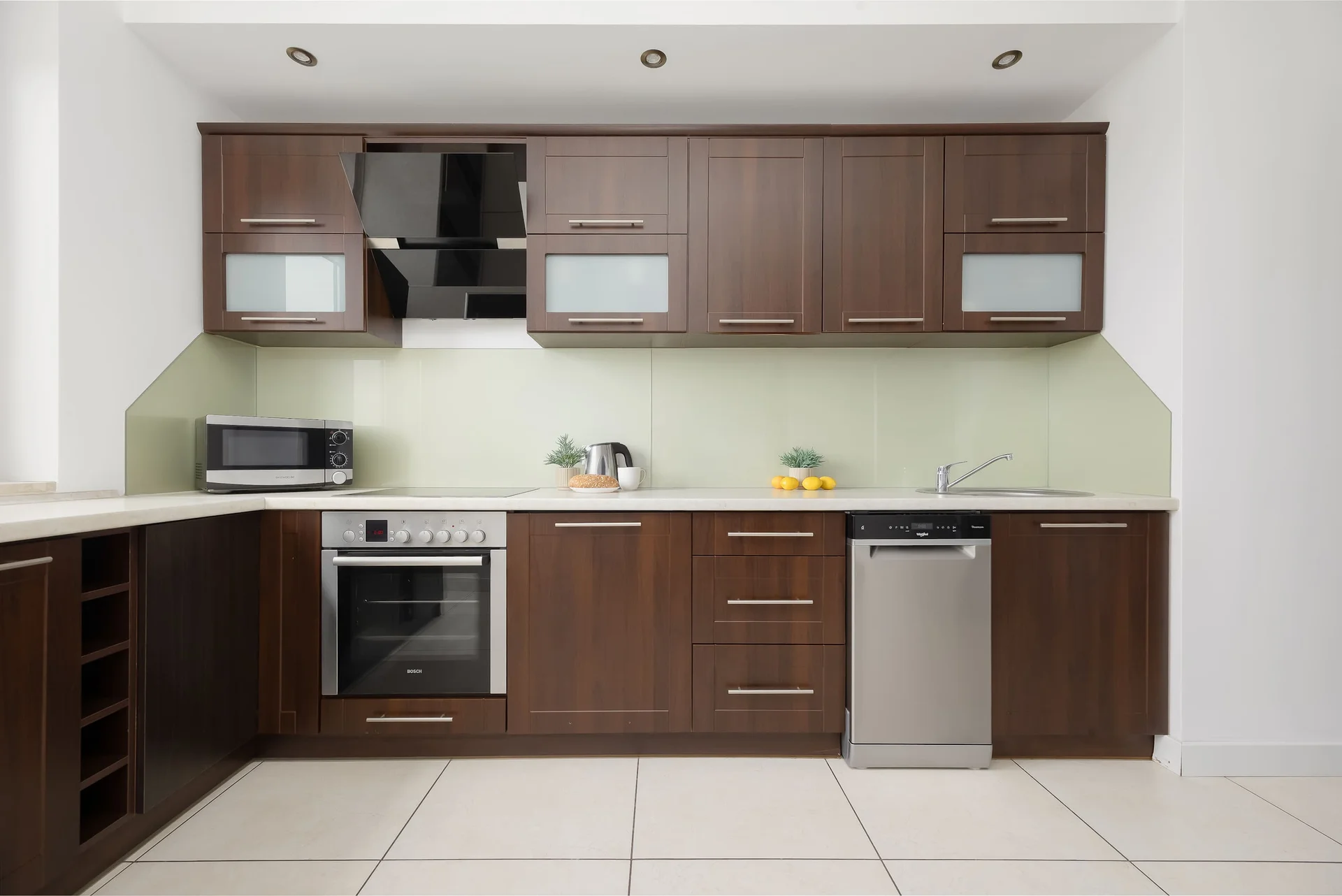 Modern kitchenette with built-in appliances and ample cabinet space.