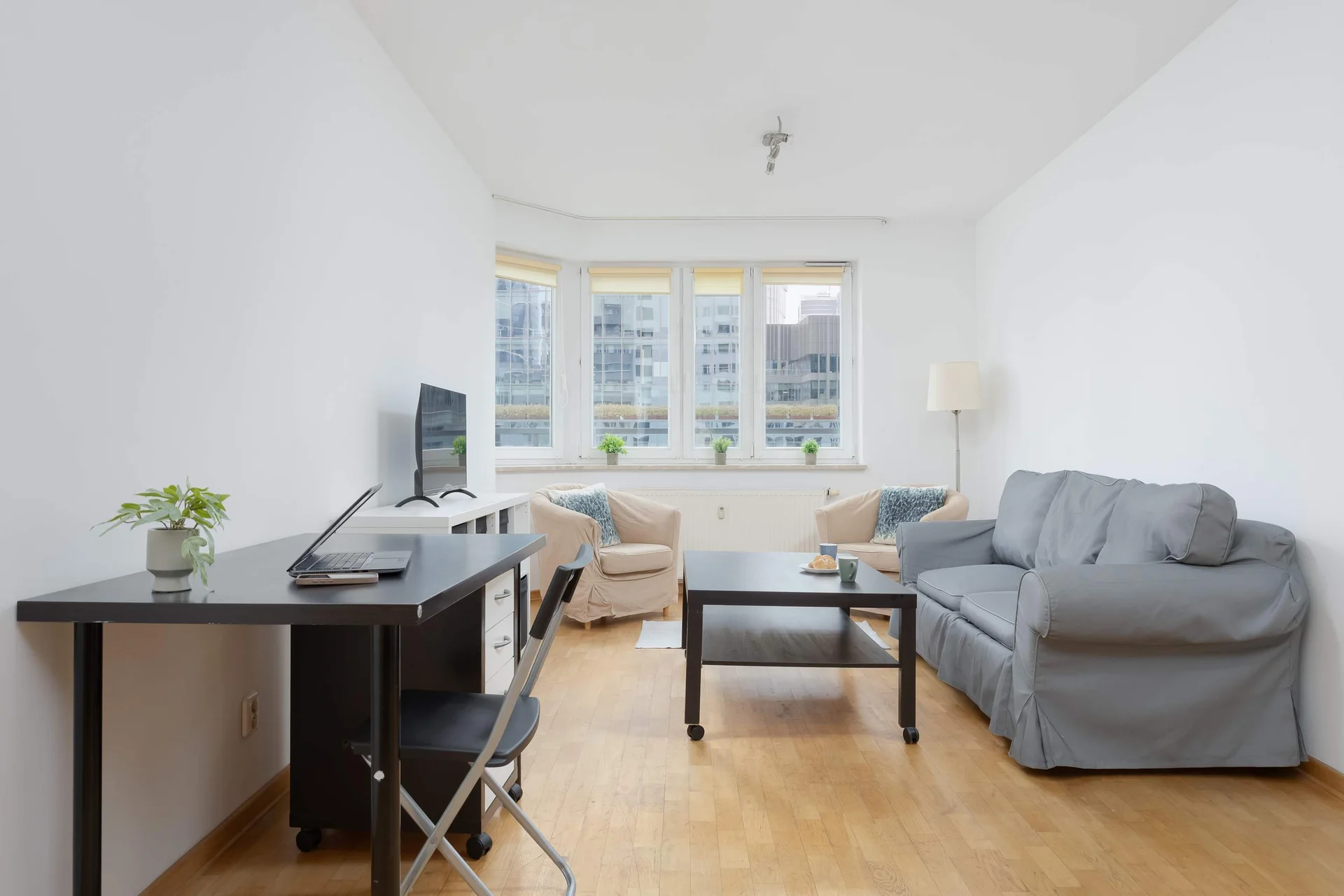 A welcoming living room with a sofa, TV, and coffee table. Spend quality time here after a day of sightseeing or work.