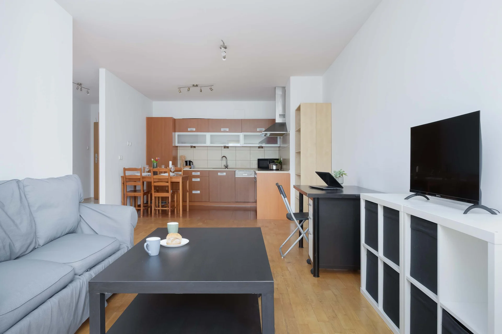 An open-plan living area connected to a fully equipped kitchenette. Relax on the sofa while enjoying the spacious interior.