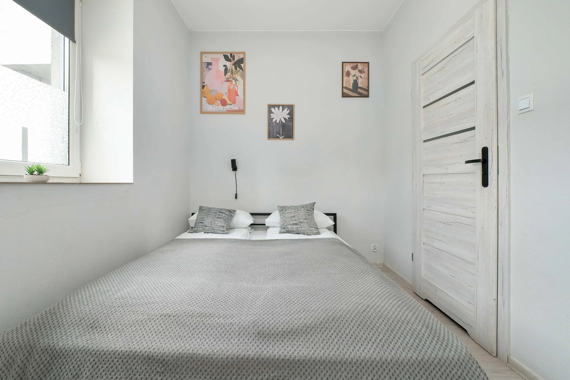 A cozy sleeping area with a comfortable double bed and a spacious wardrobe. The light décor creates a relaxing atmosphere.