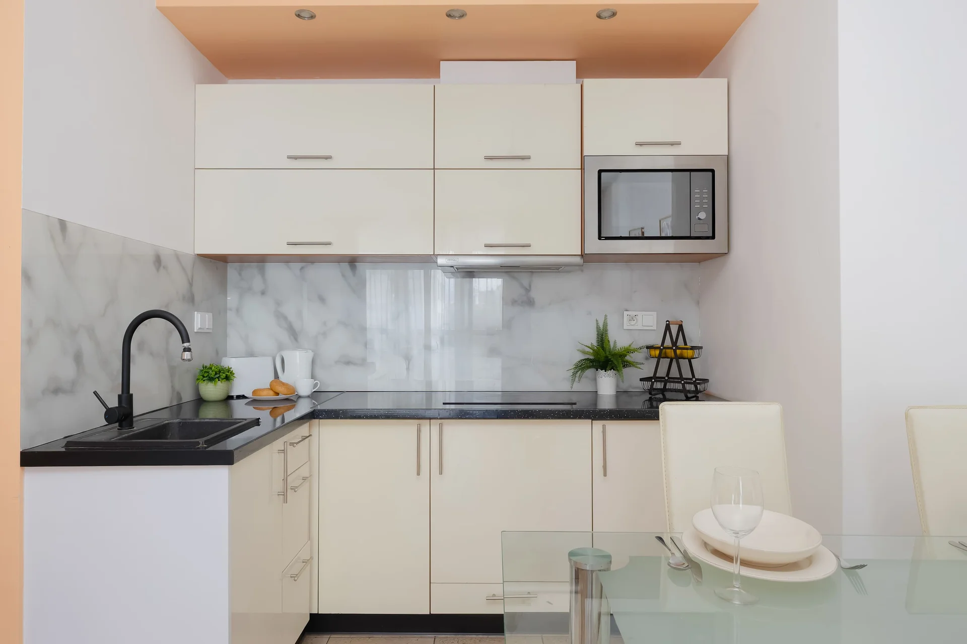 Fully equipped kitchenette with cabinets, microwave and cooking area.