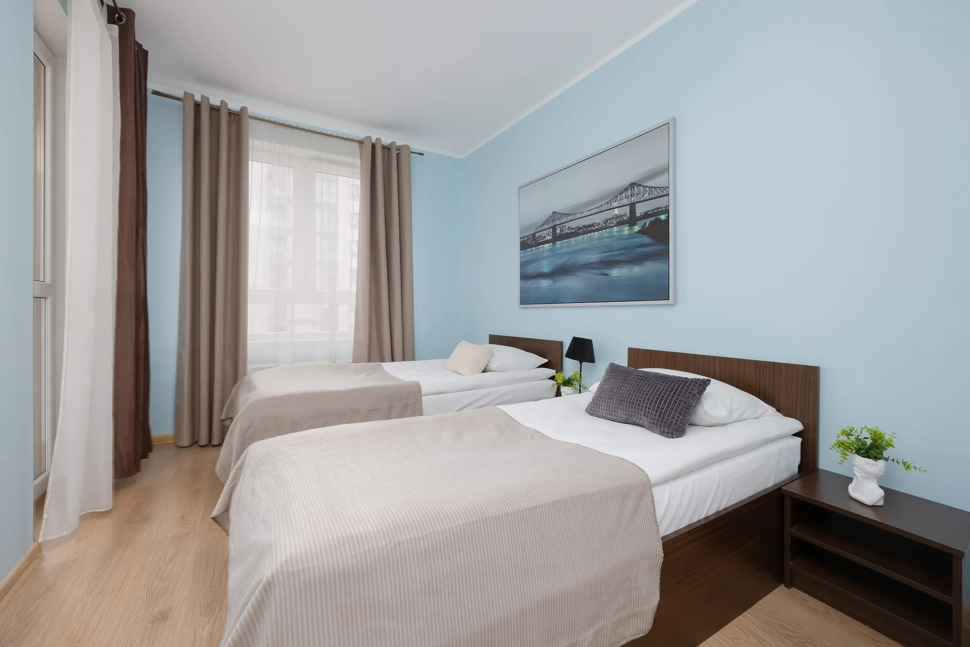 Bedroom with two single beds, bedside tables and a wardrobe.