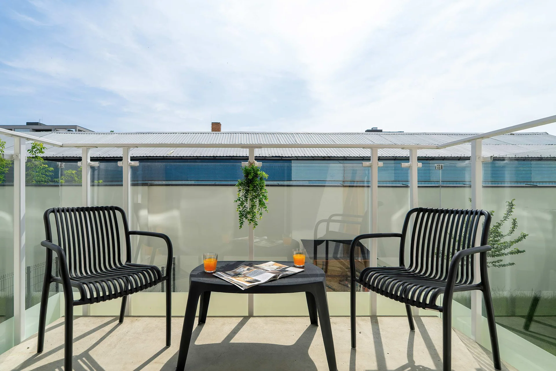 Sunny terrace furnished with outdoor seating and offering an inviting space to relax.
