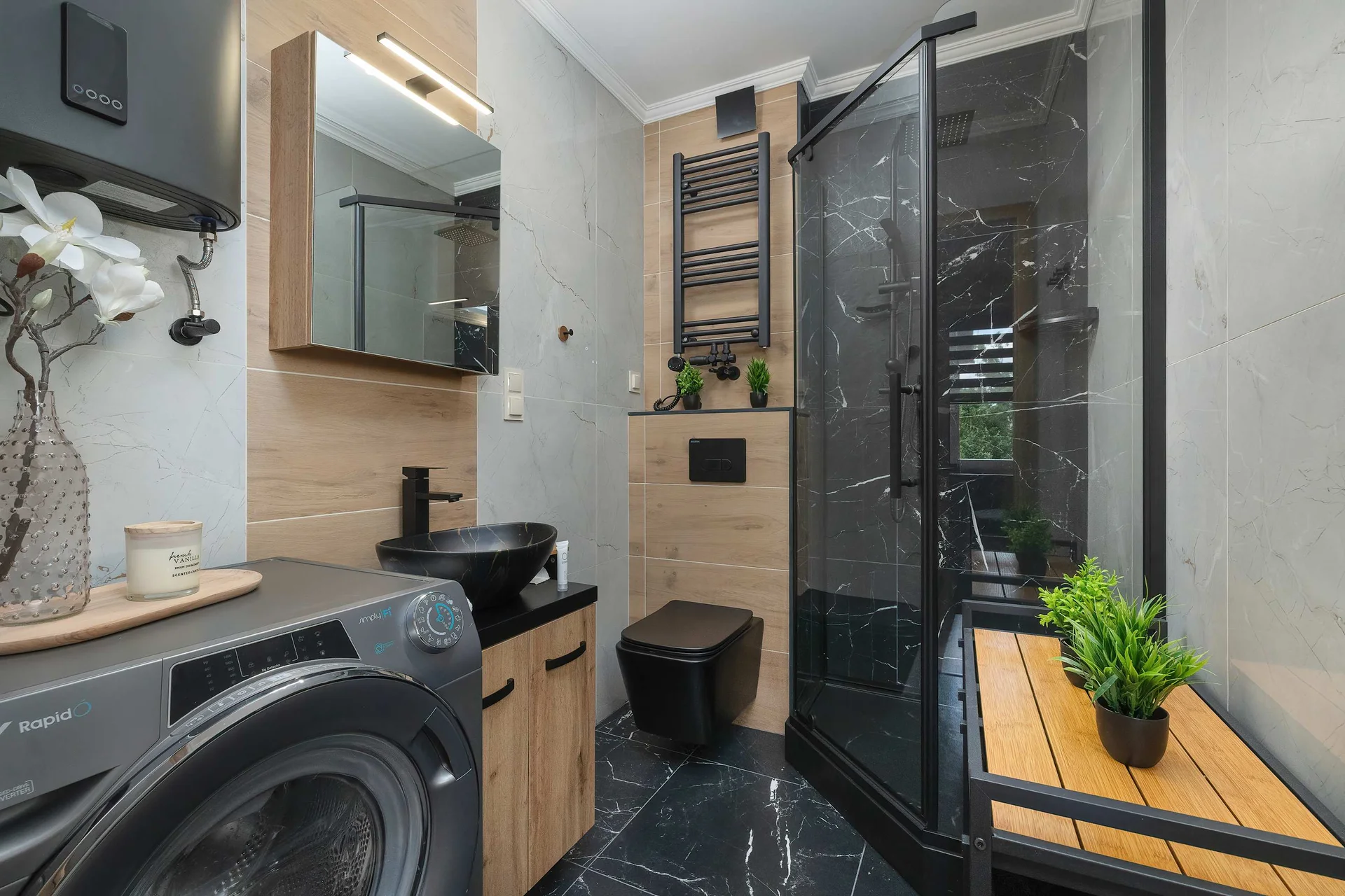 The bathroom's contemporary design includes fresh towels and a hairdryer.