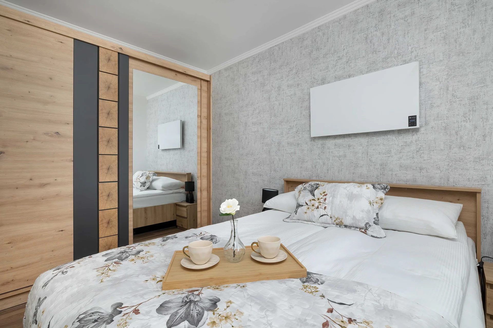 The cosy bedroom features a luxurious double bed and ample storage.