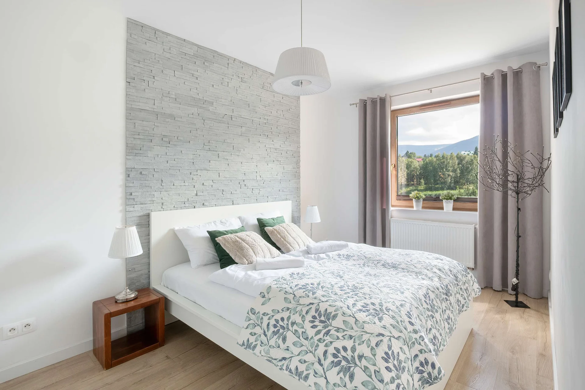The cosy bedroom features a luxurious double bed and ample storage.