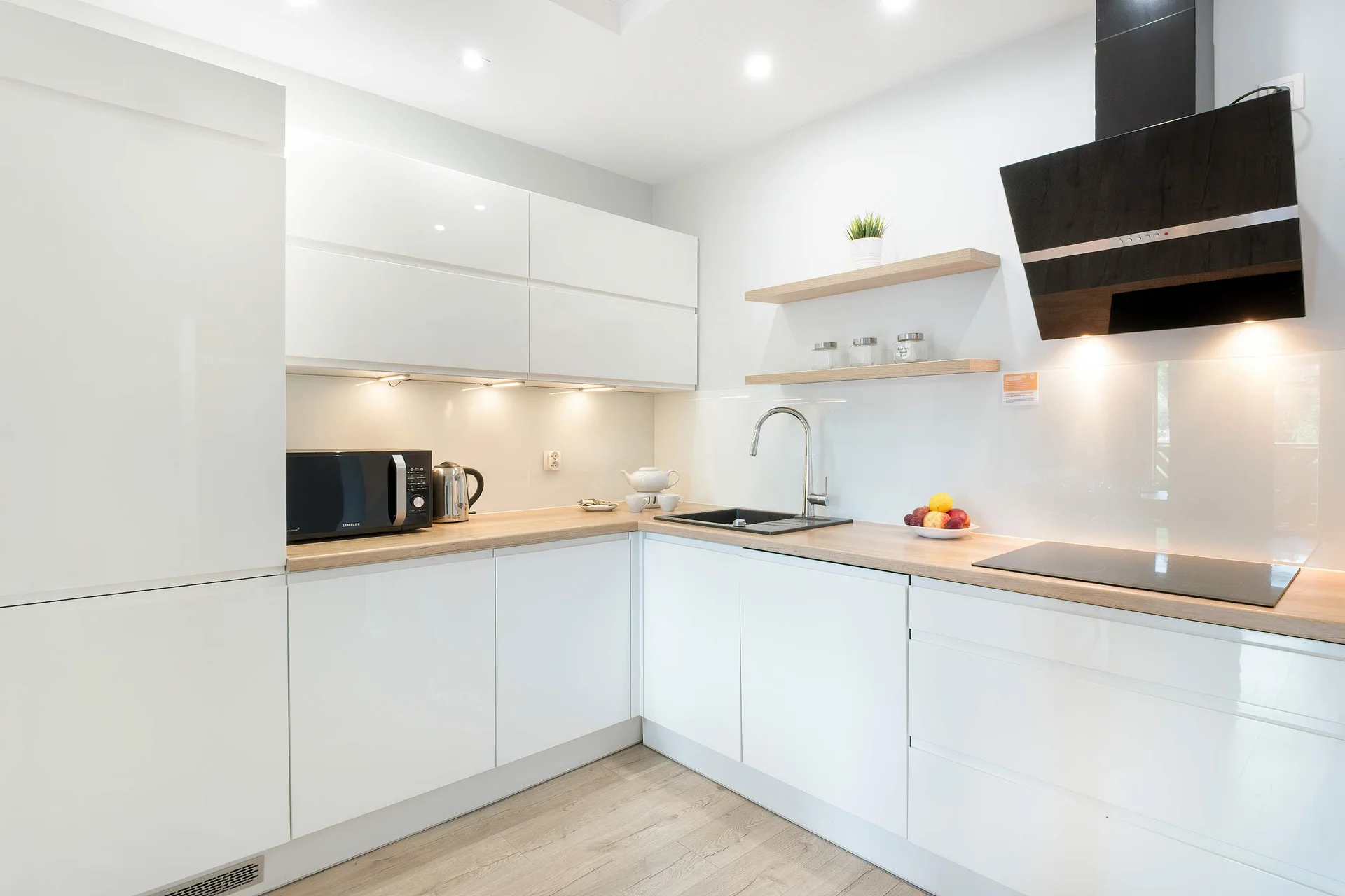The sleek design of the kitchenette blending seamlessly with the living area.