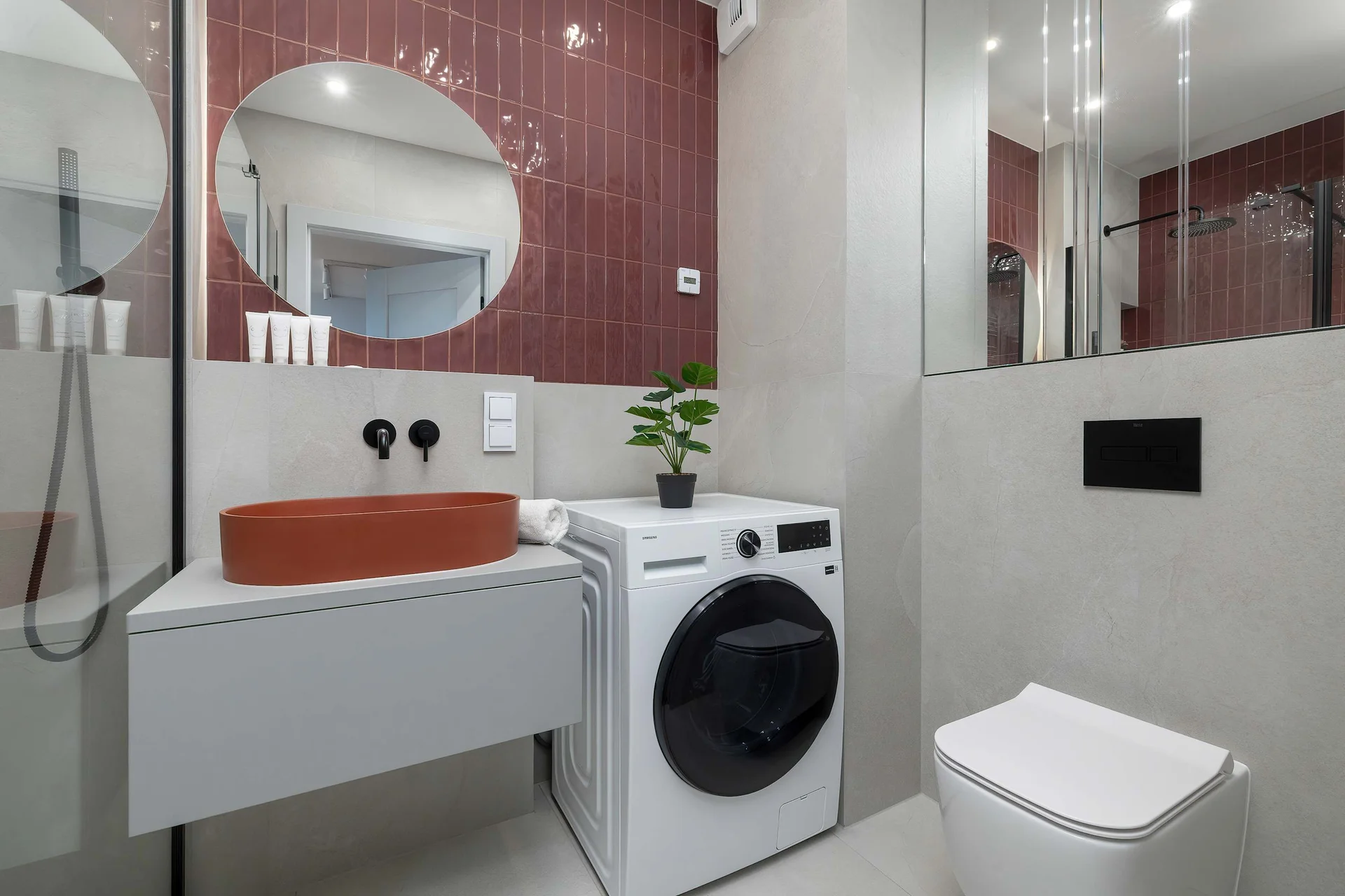 The bathroom's contemporary design includes fresh towels and a hairdryer.