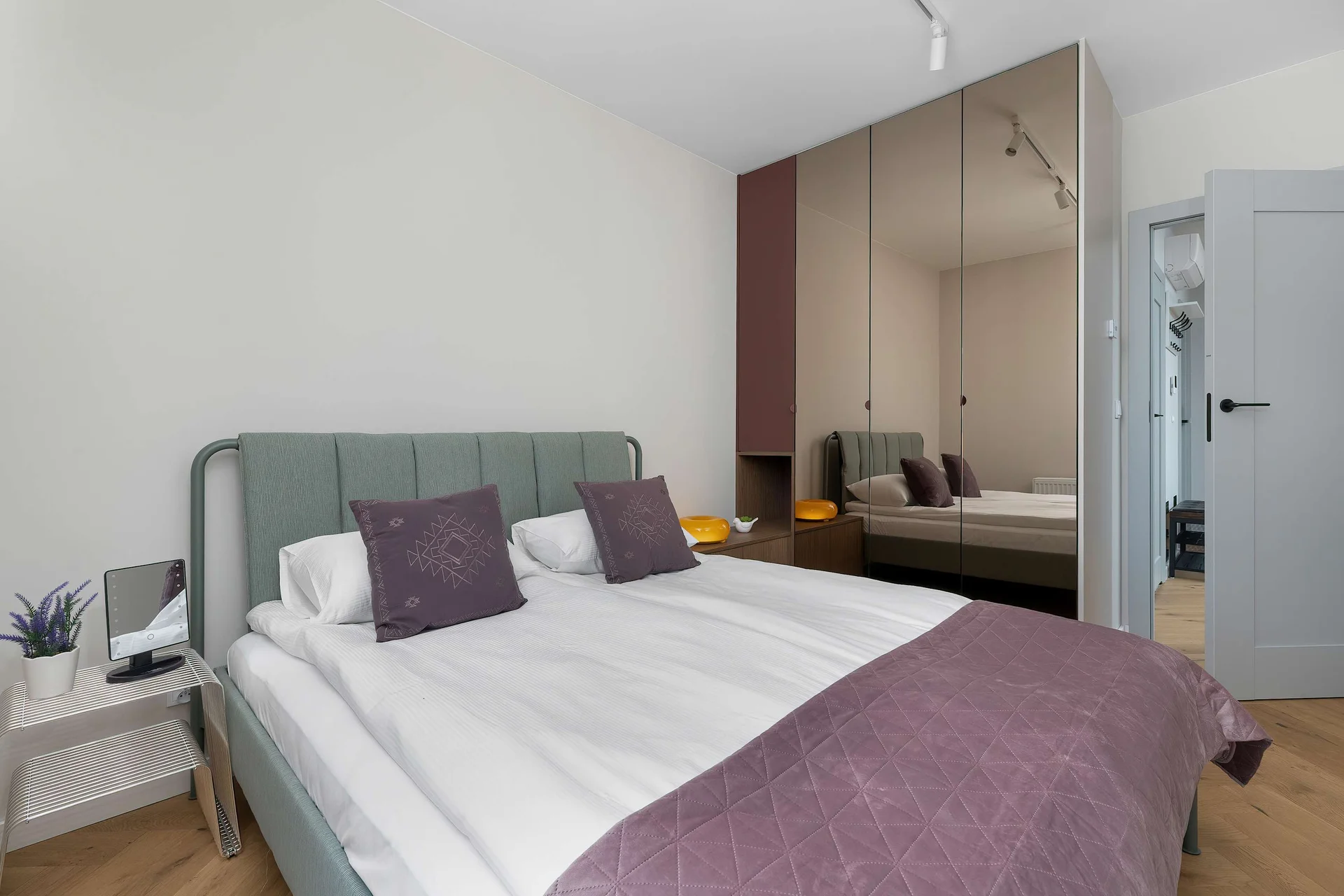 The cosy bedroom features a luxurious double bed and ample storage.