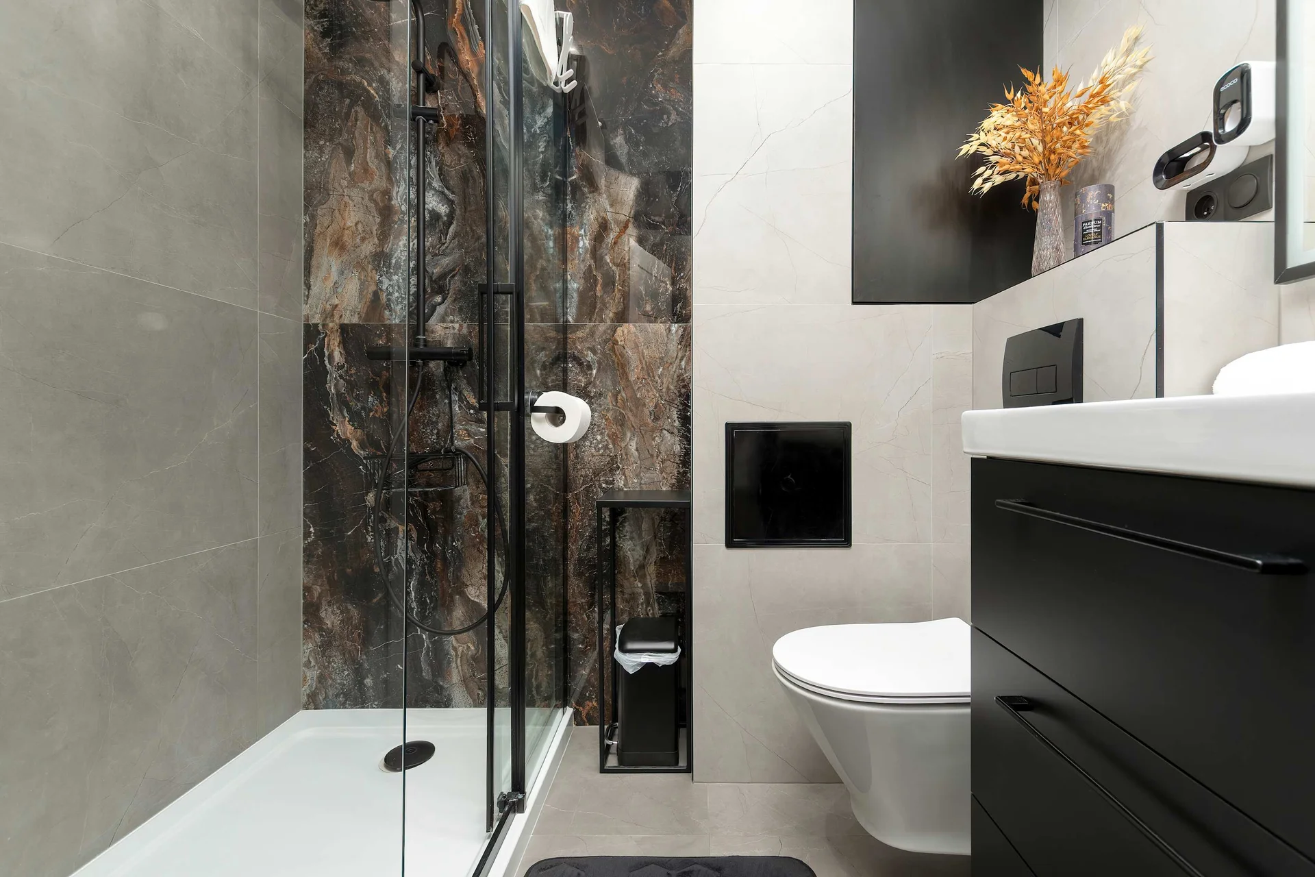 The bathroom's contemporary design includes fresh towels and a hairdryer.
