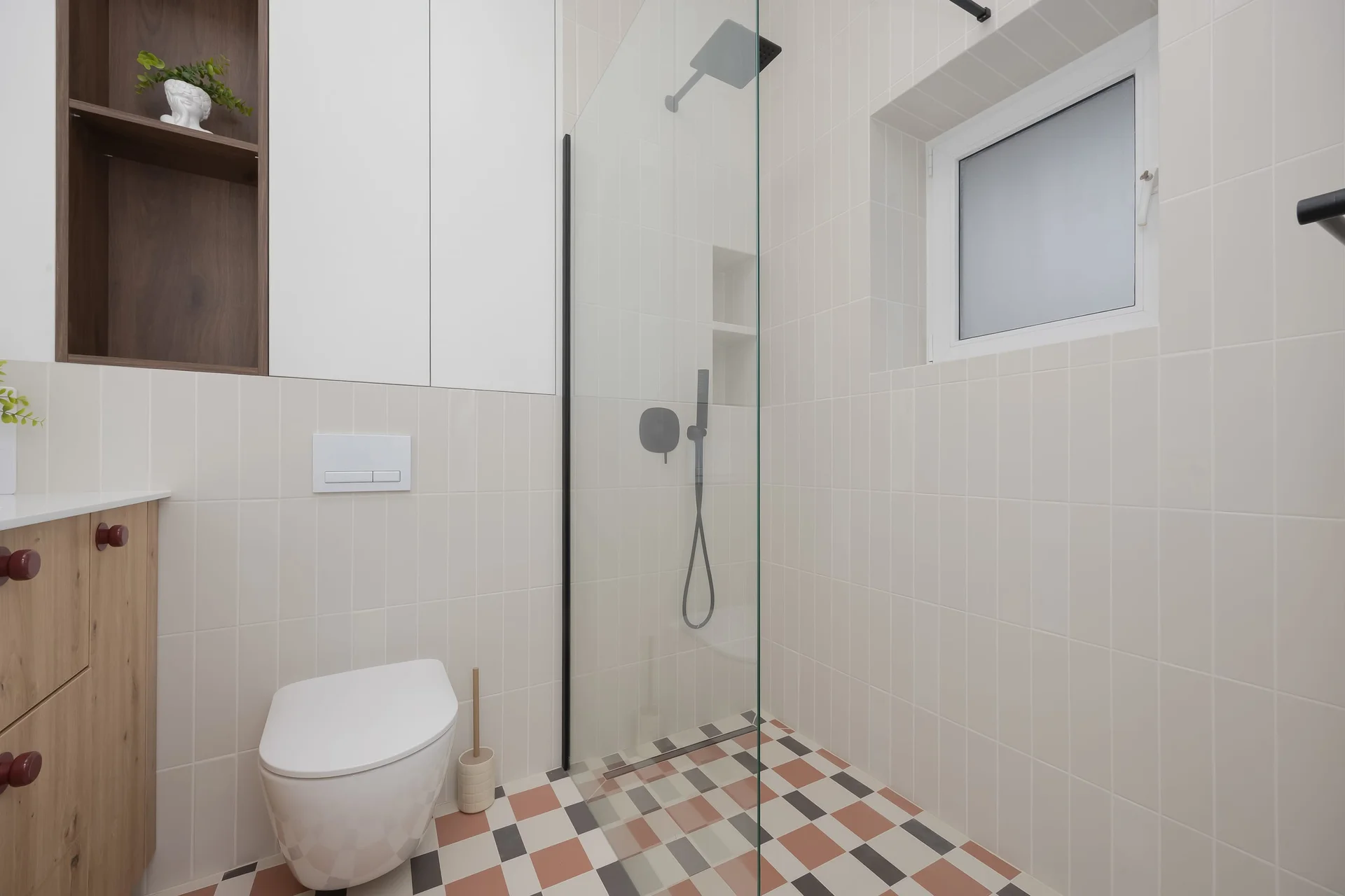 The bathroom's contemporary design includes fresh towels and a hairdryer.