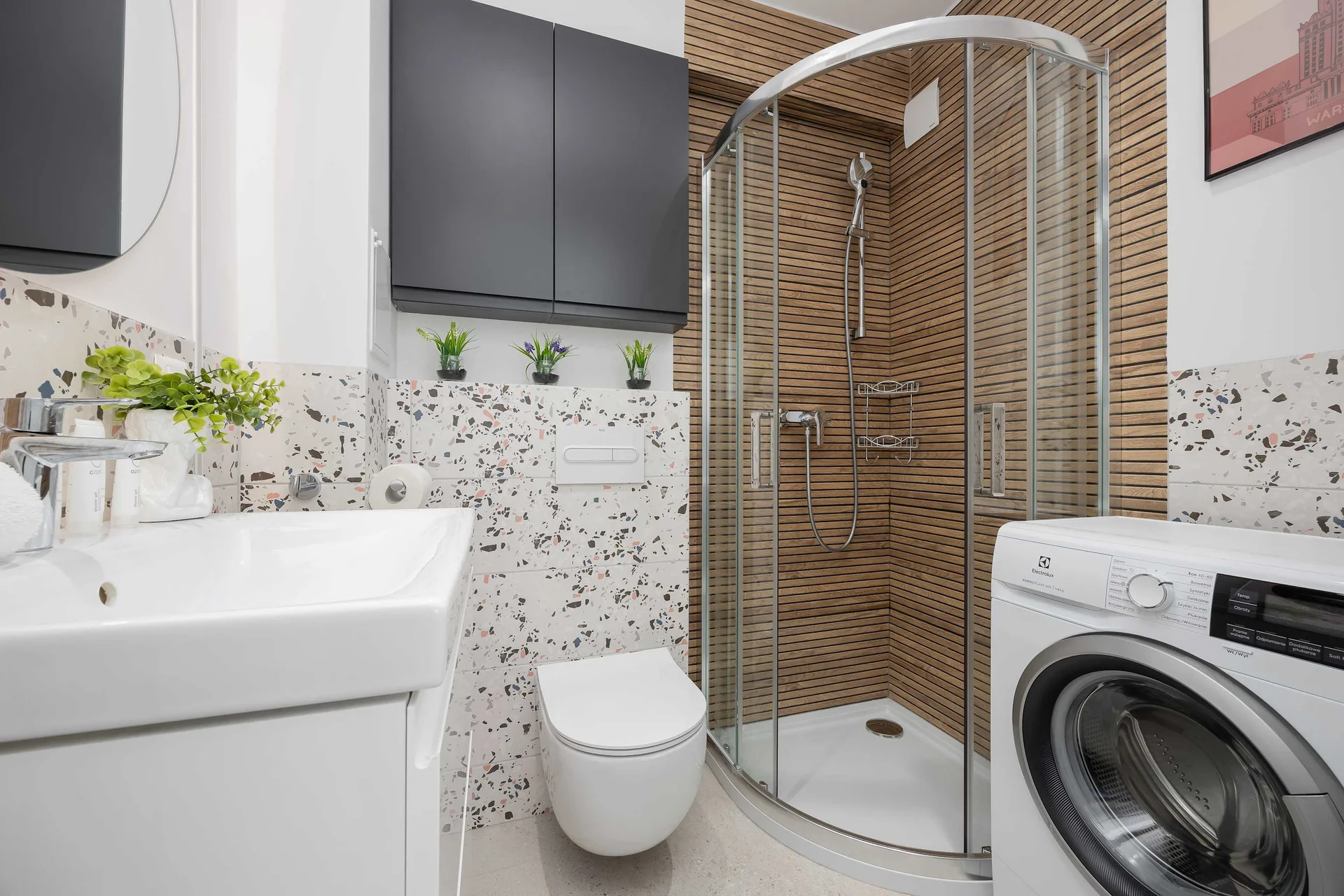 The bathroom's contemporary design includes fresh towels and a hairdryer.