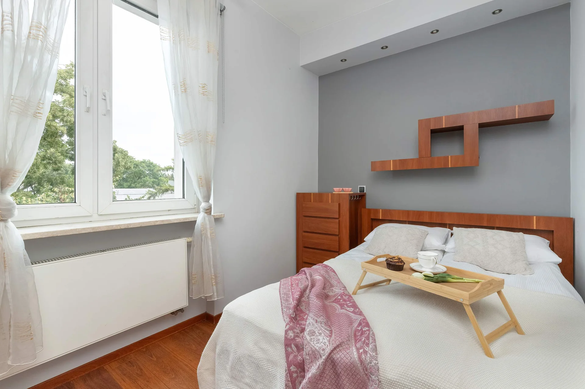 The cosy bedroom features a luxurious double bed and ample storage.