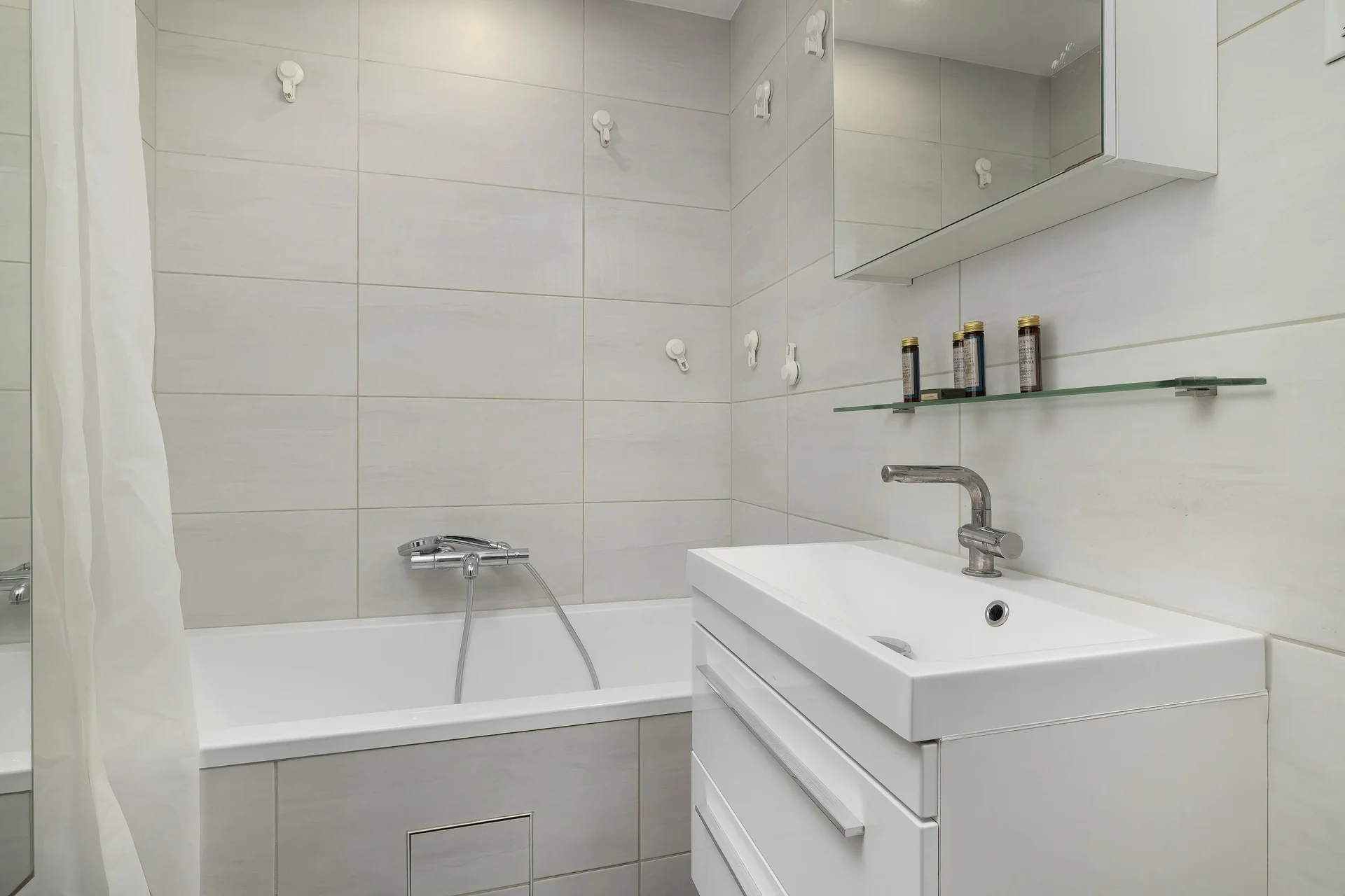 The bathroom features a modern bathtub and sleek fixtures.