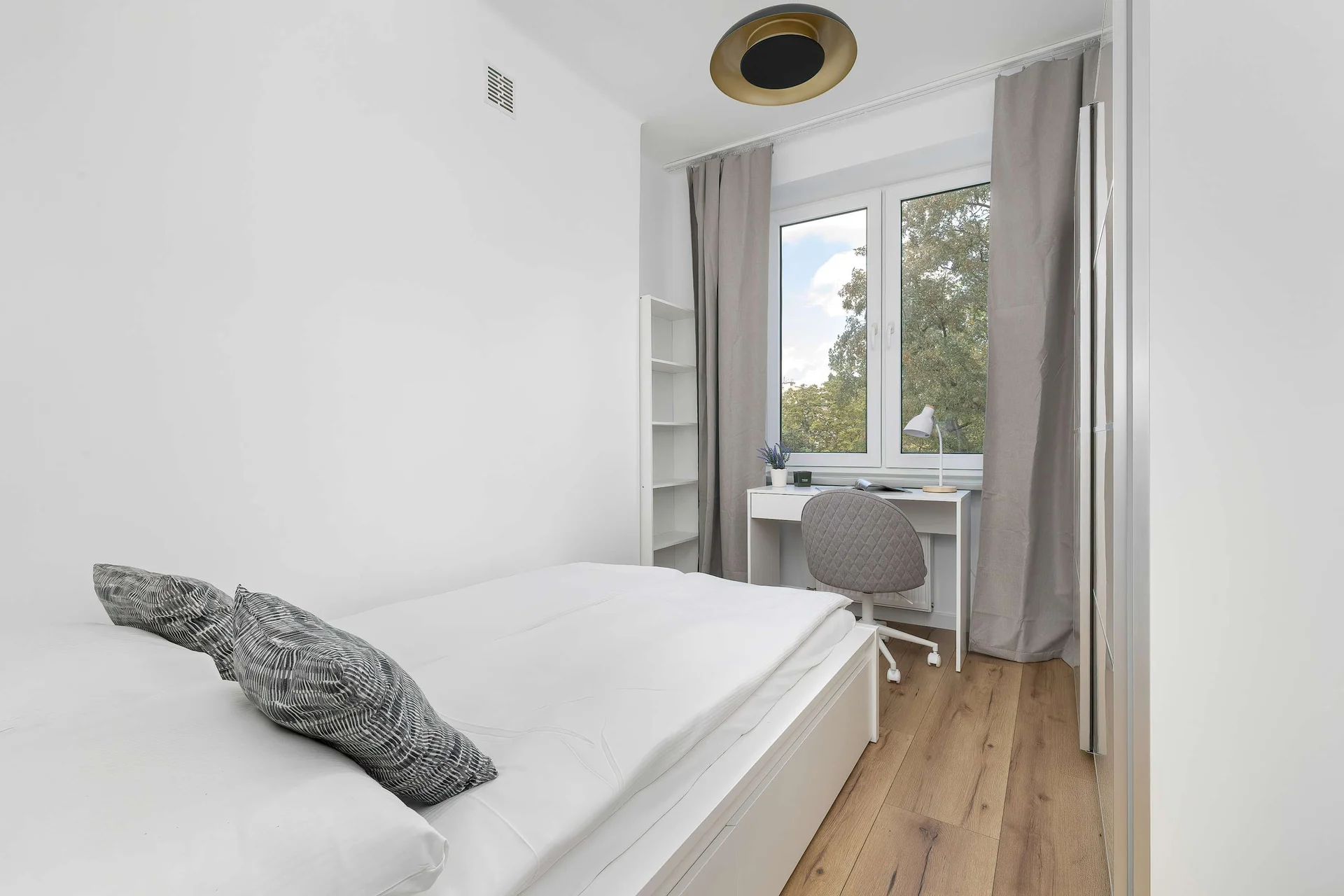 The bedroom's modern design ensures a comfortable stay.