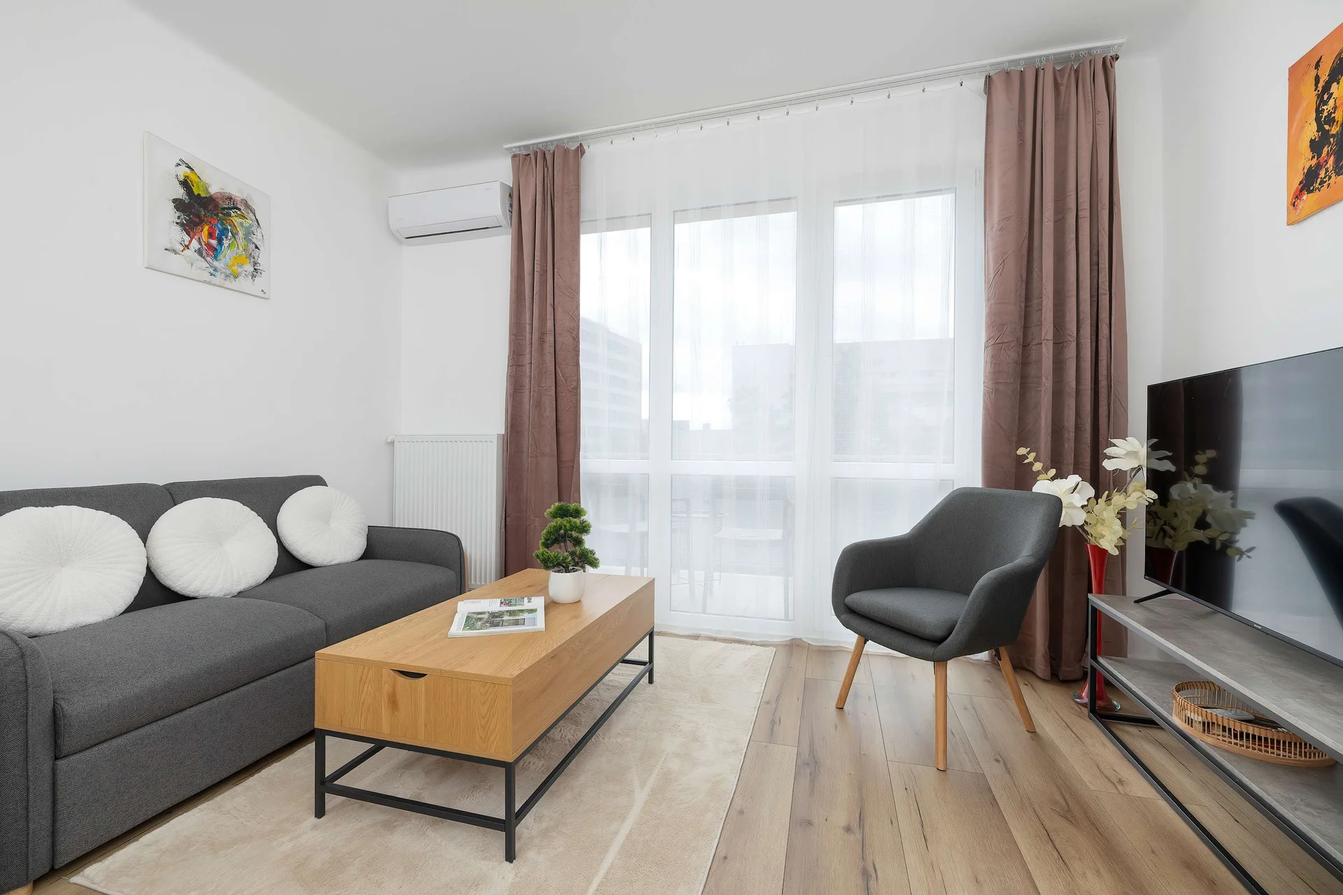 Relax in the stylish living room with a comfortable sofa and modern decor.