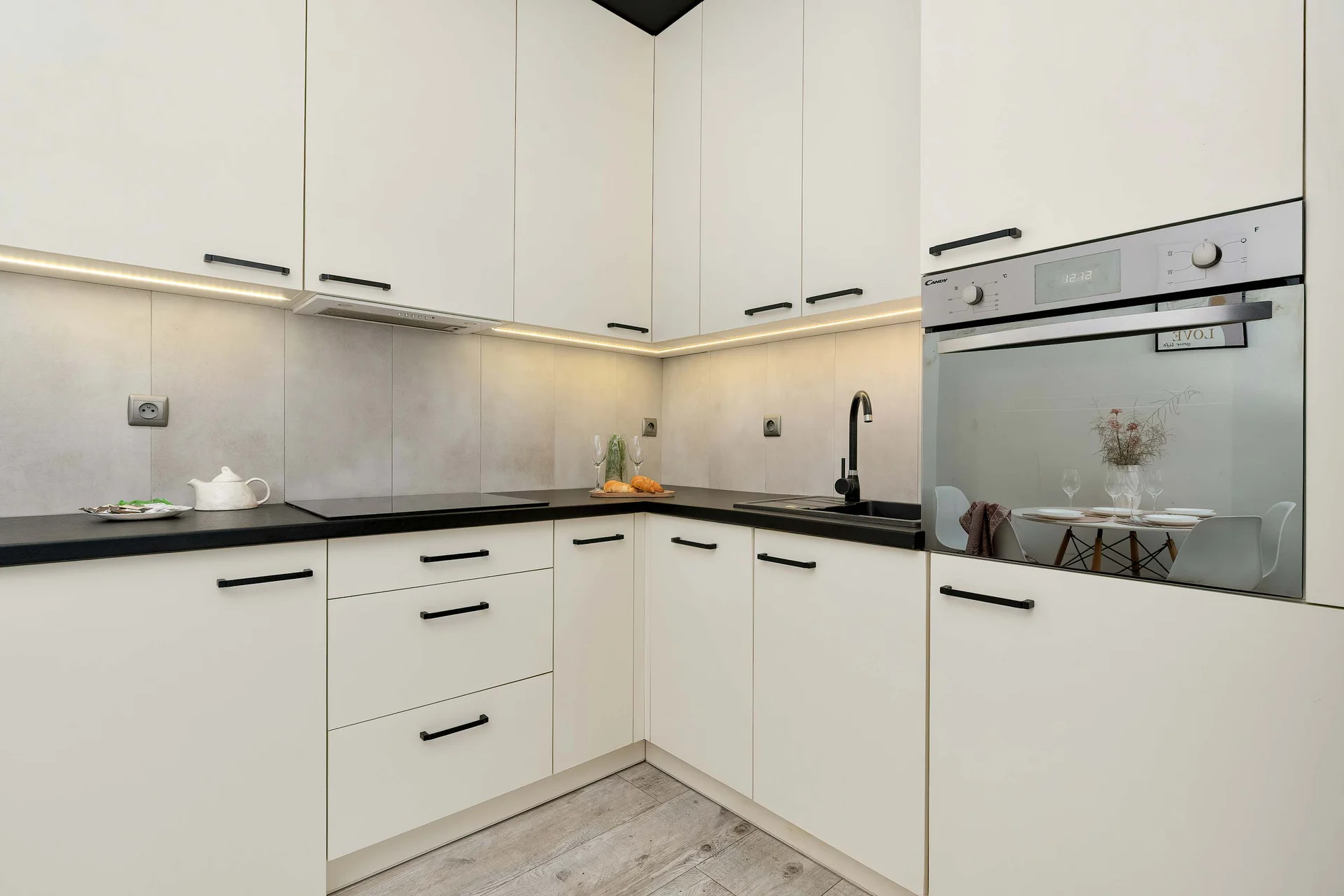 The sleek design of the kitchenette blending seamlessly with the living area.