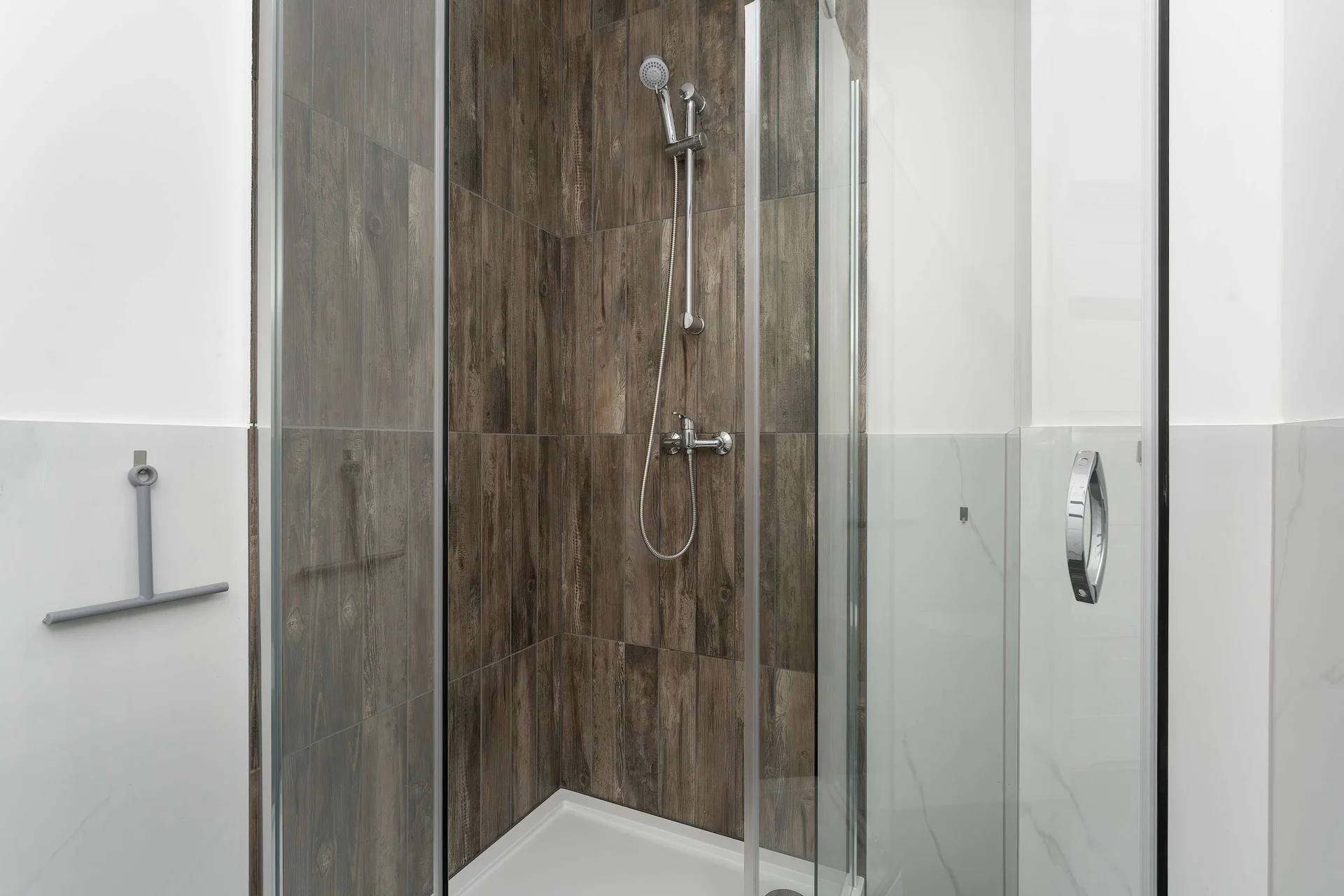 The bathroom's contemporary design includes fresh towels and a hairdryer.