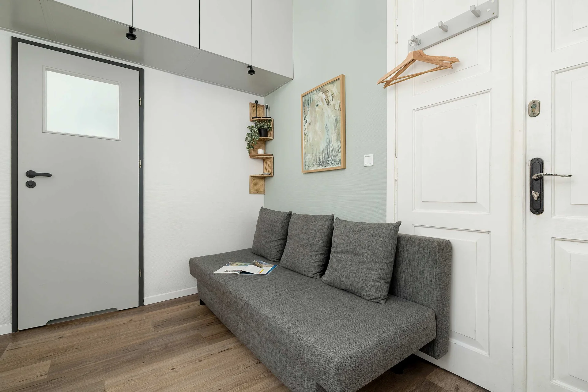 Relax in the stylish living area with a comfortable sofa and modern decor.