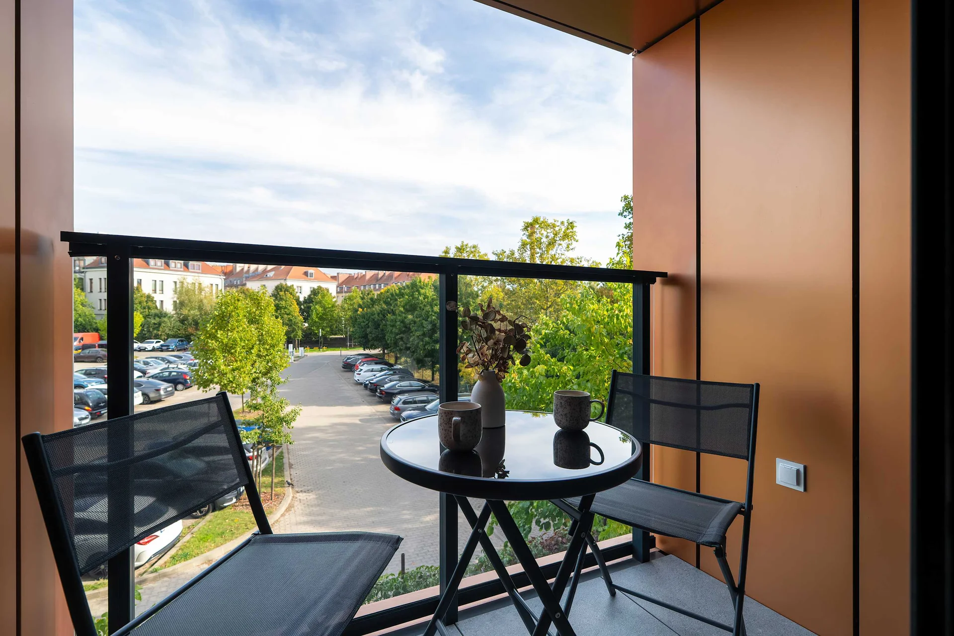 Spacious balcony with outdoor seating and views of the surrounding area.