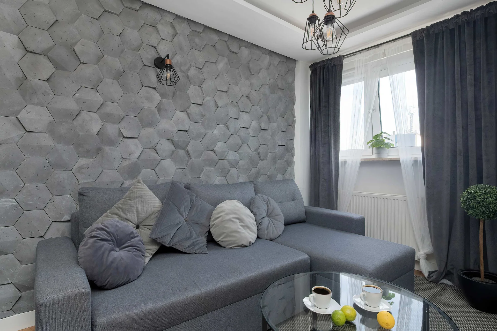 Relax in the stylish living room with a comfortable sofa and modern decor.