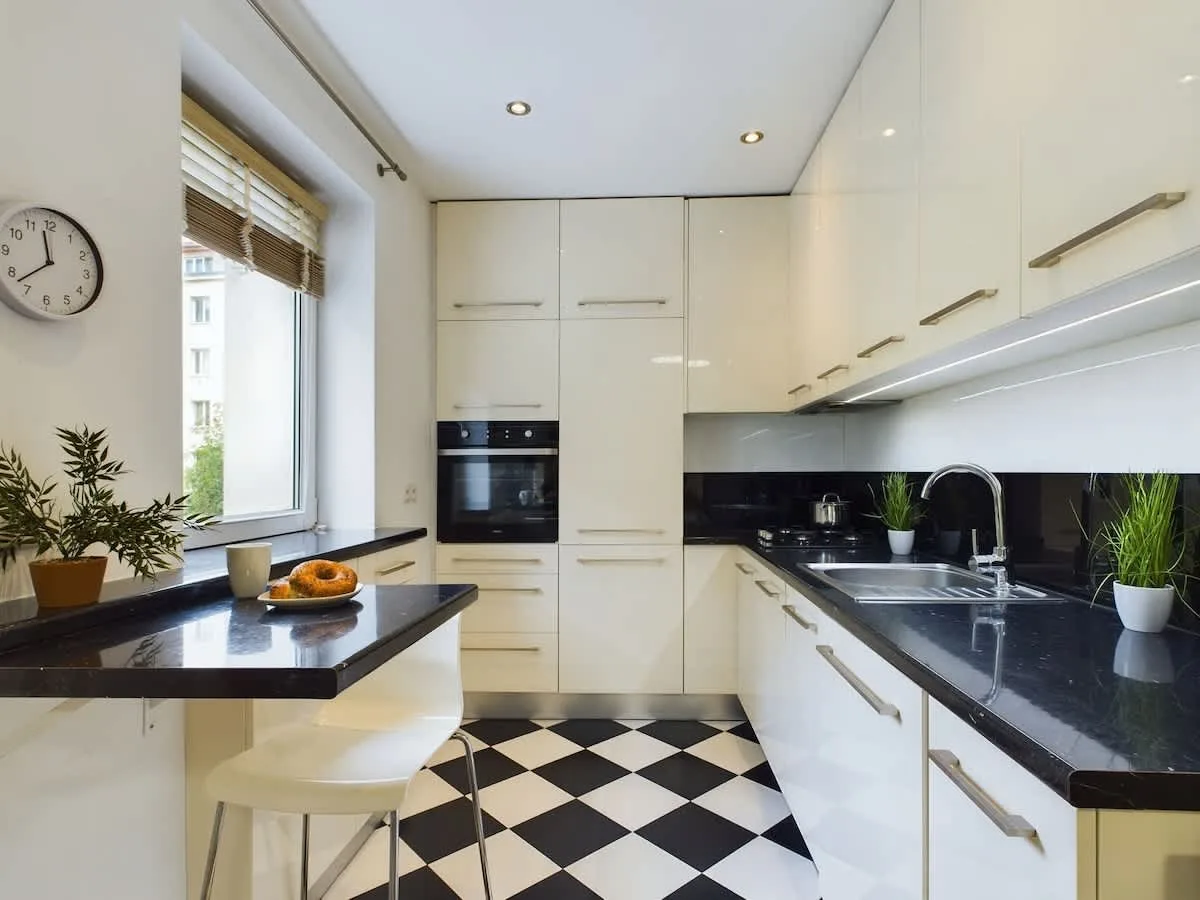 Modern kitchenette with bright cabinets.