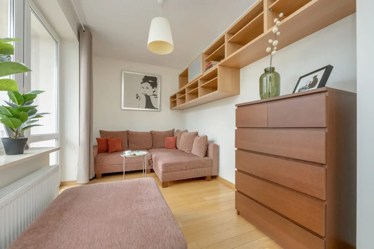 A modern study corner with built-in wooden shelves, a comfortable bench, and a decorative plant, offering a perfect space for reading and relaxation.