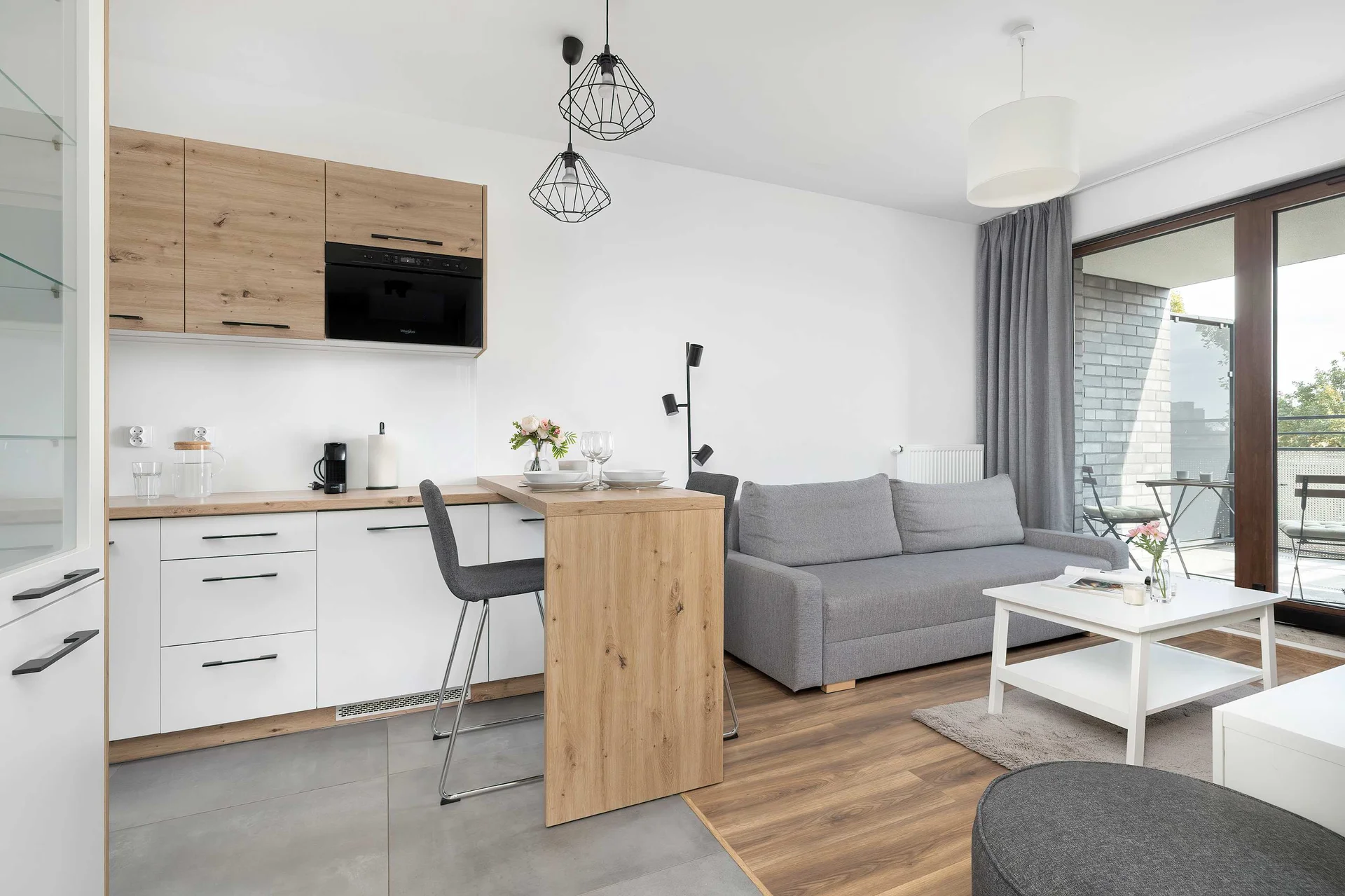Modern kitchen with an island and wooden fronts encourages cooking in a warm, homely atmosphere.
